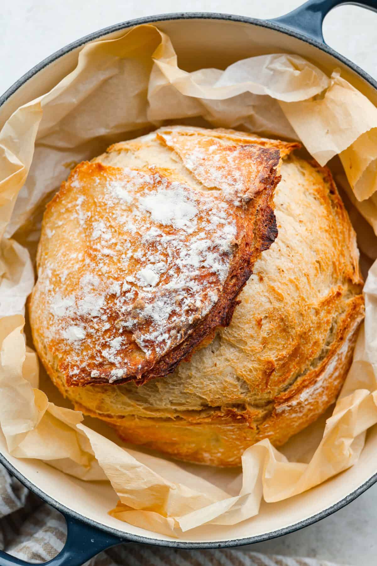 Myย 4-ingredient artisan breadย is simple, rustic, and completely bakery-worthy. With just flour, water, yeast, and salt, youโll get a crusty loaf with a soft, chewy center, no fuss required. Overhead shot of completely cooked artisan bread in a dutch oven surrounded by parchment paper.