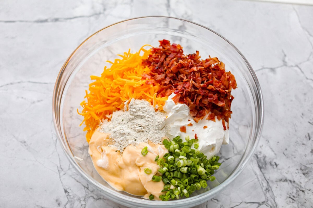 Crack tater tot casserole is bold, cozy, and a little bit addictive, in the best way! Creamy, cheesy, and topped with crispy tots, it’s the kind of dinner everyone gets excited about. All of the sauce ingredients added to a bowl.