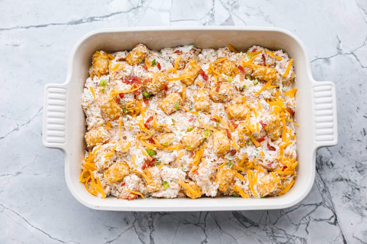 Crack tater tot casserole is bold, cozy, and a little bit addictive, in the best way! Creamy, cheesy, and topped with crispy tots, it’s the kind of dinner everyone gets excited about. Tater tot and sauce mixture added to the bottom of the prepared baking dish.