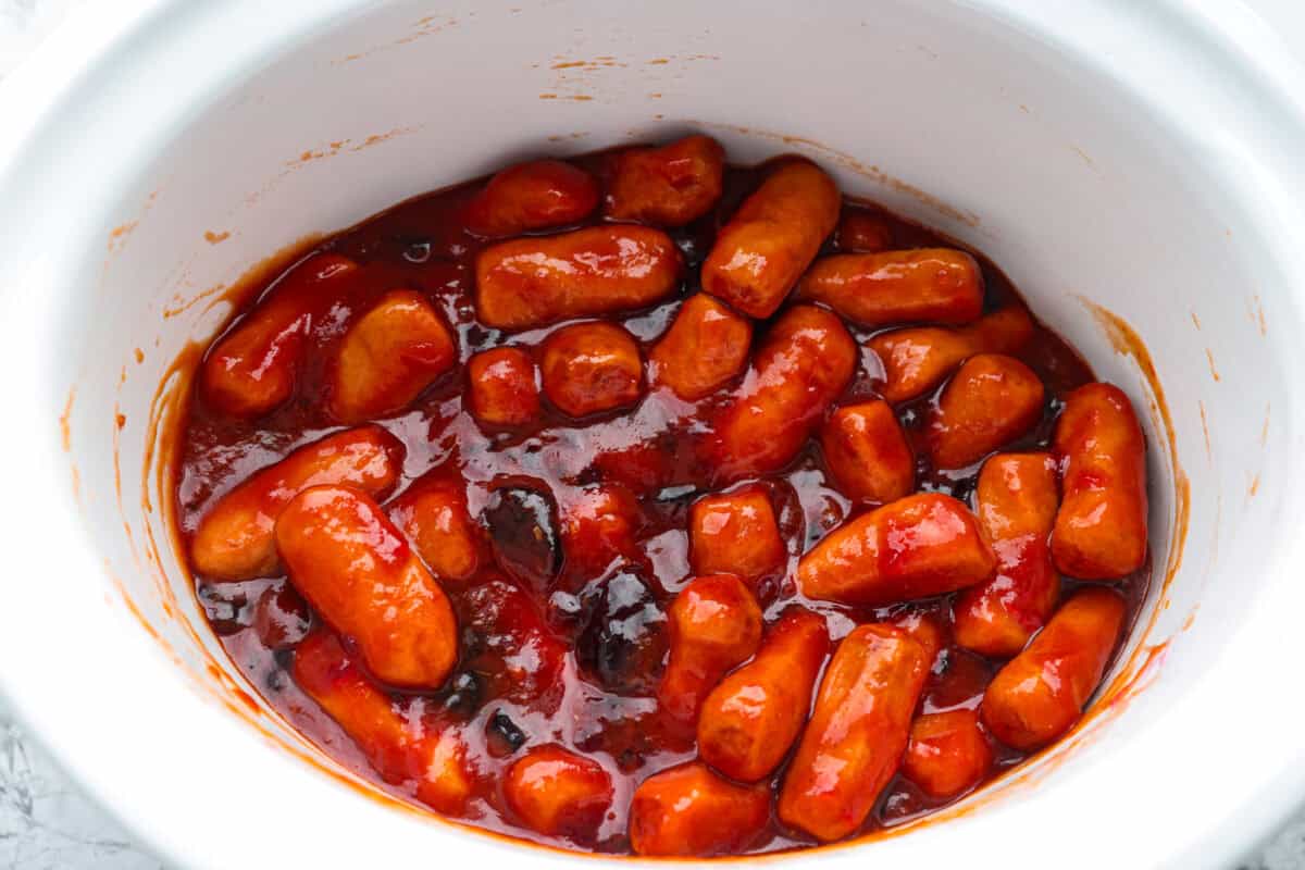 If youโre hosting anything and need a quick appetizer, these crockpot grape jelly little smokies are it. Dump everything in the slow cooker, walk away, and come back to glossy, flavorful sausages that people hover around all night. Everything mixed together ready to cook.