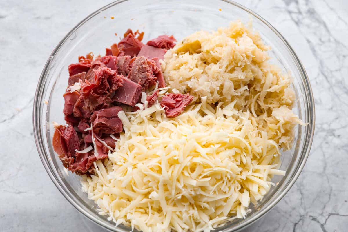 Think of this hot Reuben dip as a love letter to the classic Reuben sandwich. Itโs rich, tangy, loaded with corned beef and sauerkraut, and the perfect way to turn St. Patrickโs Day leftovers into something everyone fights over. Sauerkraut, corned been and Swiss cheese added to the mixture.