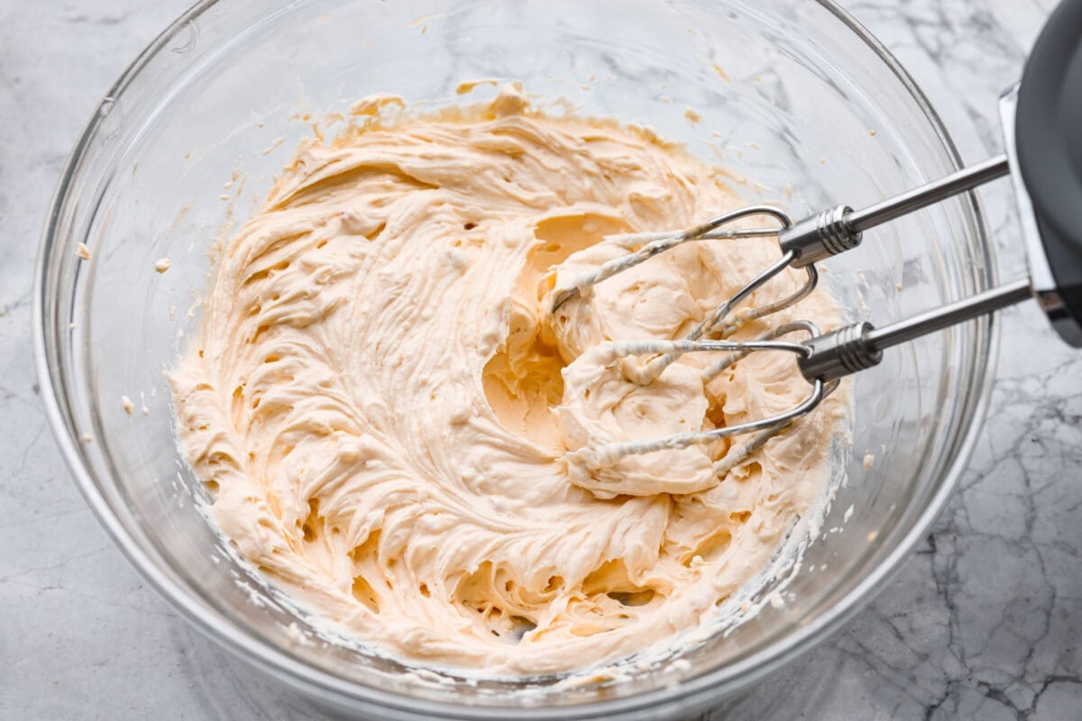 Think of this hot Reuben dip as a love letter to the classic Reuben sandwich. Itโs rich, tangy, loaded with corned beef and sauerkraut, and the perfect way to turn St. Patrickโs Day leftovers into something everyone fights over. Cream cheese, sour cream and thousand island dressing being beaten with a hand mixer in a mixing bowl.