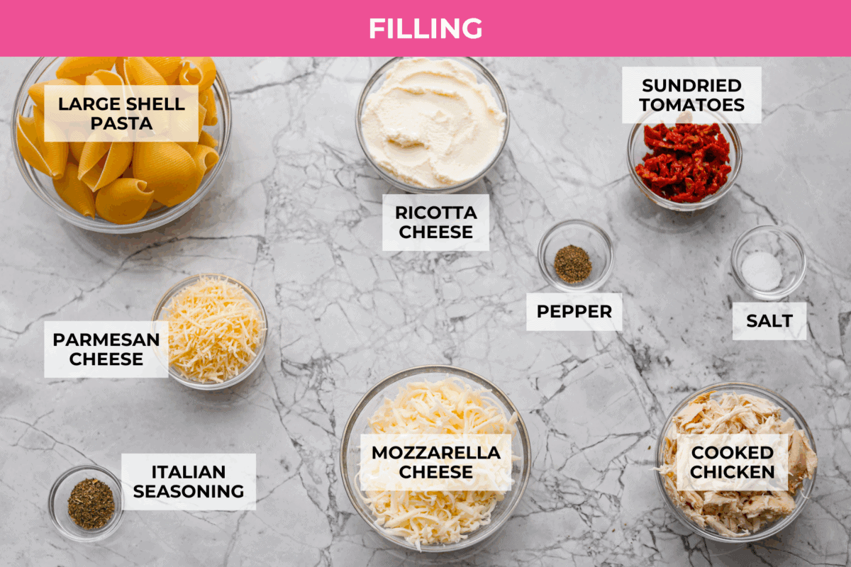 Marry me stuffed shellsย take the viral sauce you love and turn it into a cozy, baked pasta moment. Think creamy chicken-stuffed shells, melty cheese, and just enough sun-dried tomatoes for that extra swoon-worthy touch. Overhead shot of the labeled marry me stuffed shells filling ingredients.