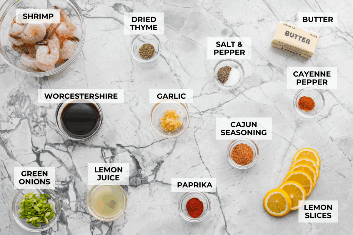 You have to make this New Orleans BBQ shrimp! The shrimp are tender and swimming in a rich, buttery garlic sauce. Grab a bib, lick your fingers, and sop up every last drop with crusty bread. Overhead shot of labeled New Orleans BBQ shrimp ingredients.