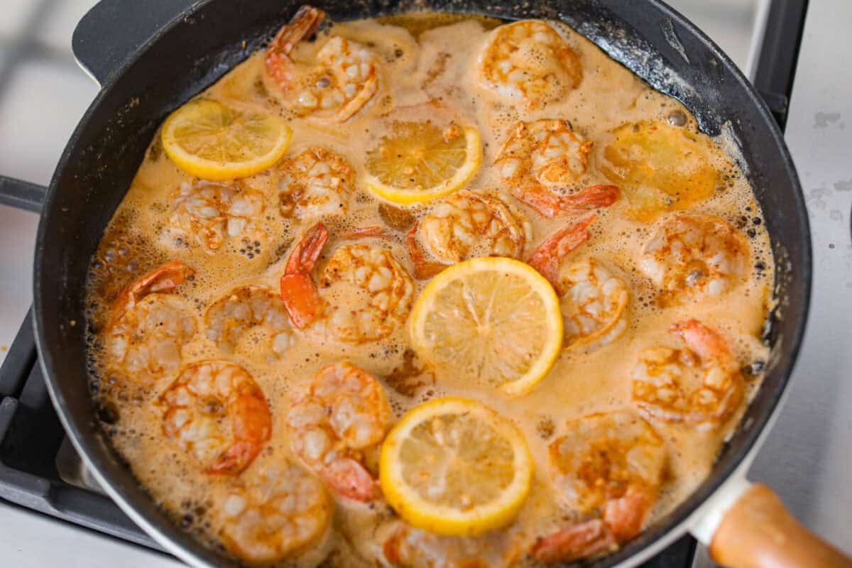 You have to make this New Orleans BBQ shrimp! The shrimp are tender and swimming in a rich, buttery garlic sauce. Grab a bib, lick your fingers, and sop up every last drop with crusty bread. Worcestershire sauce and lemon added to the skillet.