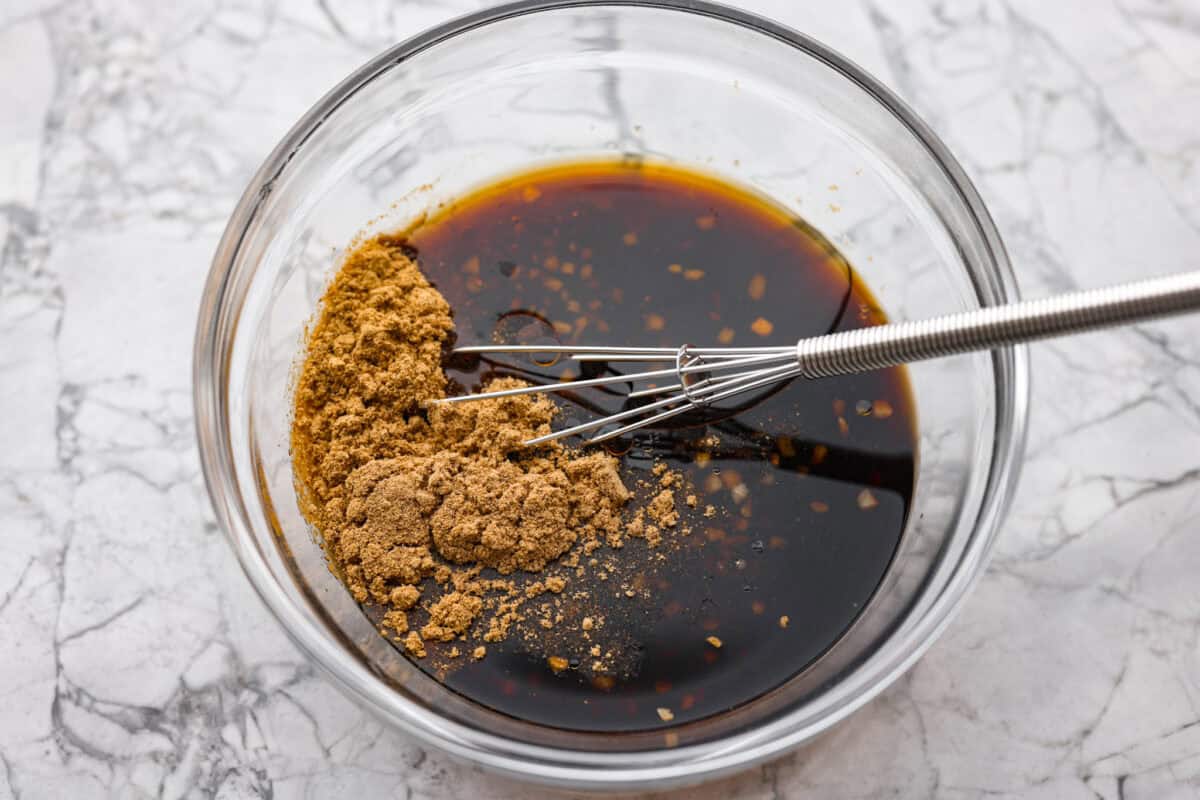 Trust me on this one. If you want the most tender pepper steak you’ve ever made at home, this recipe is it. It’s fast, saucy, and I give you just enough tips to make it work on a busy night! Sauce ingredients being whisked together in a bowl.