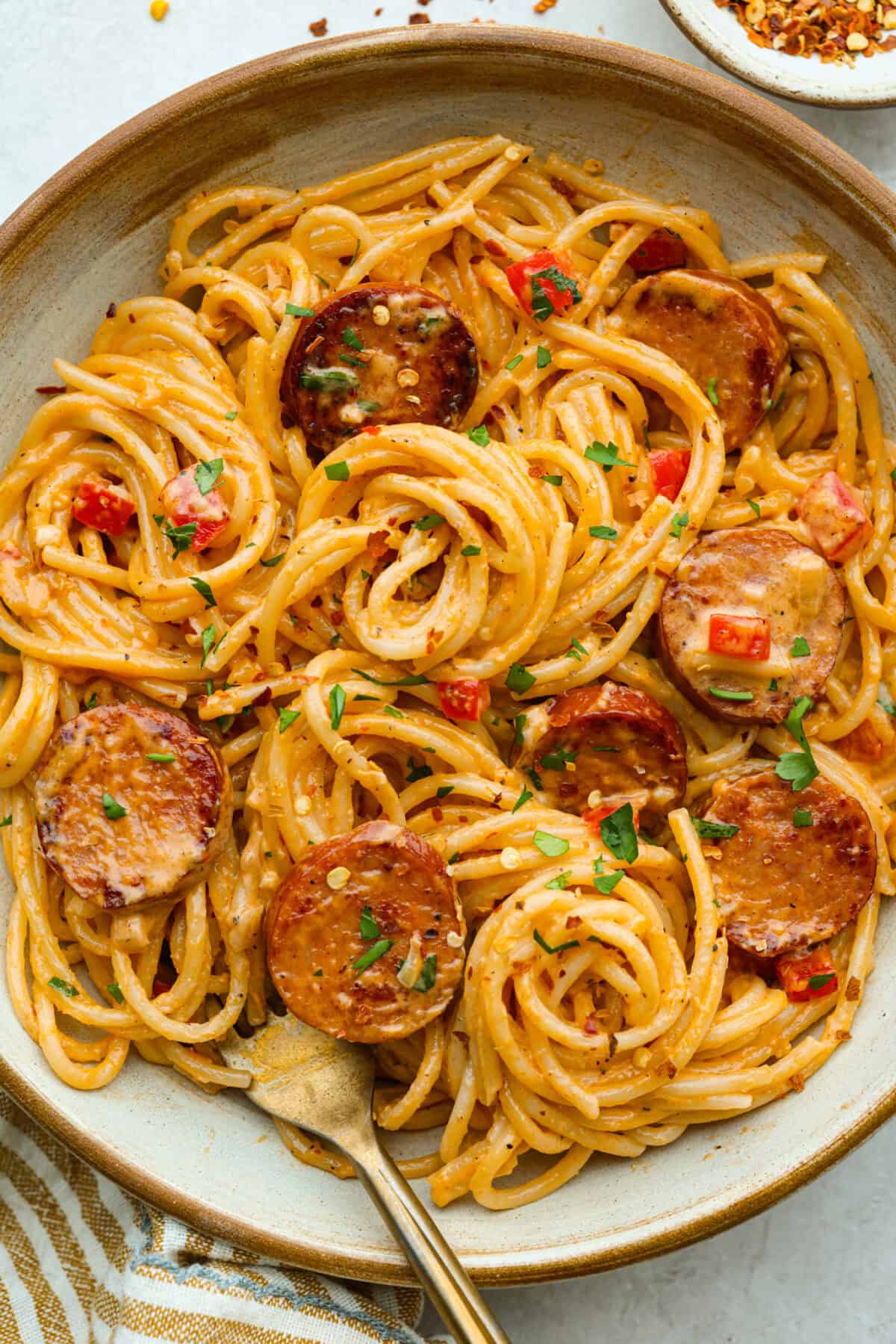 This Cajun spaghetti is comforting like classic spaghetti but delivers a bold Cajun kick with sausage and a creamy sauce. You'll have a super flavorful dinner your whole family will love in no time! Plate of Cajun spaghetti with a fork.
