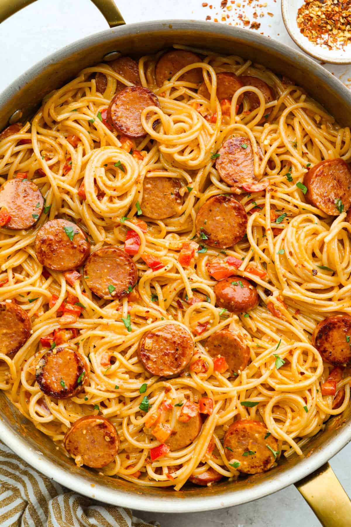 This Cajun spaghetti is comforting like classic spaghetti but delivers a bold Cajun kick with sausage and a creamy sauce. You'll have a super flavorful dinner your whole family will love in no time! Skillet of cajun spaghetti all cooked and ready to serve.