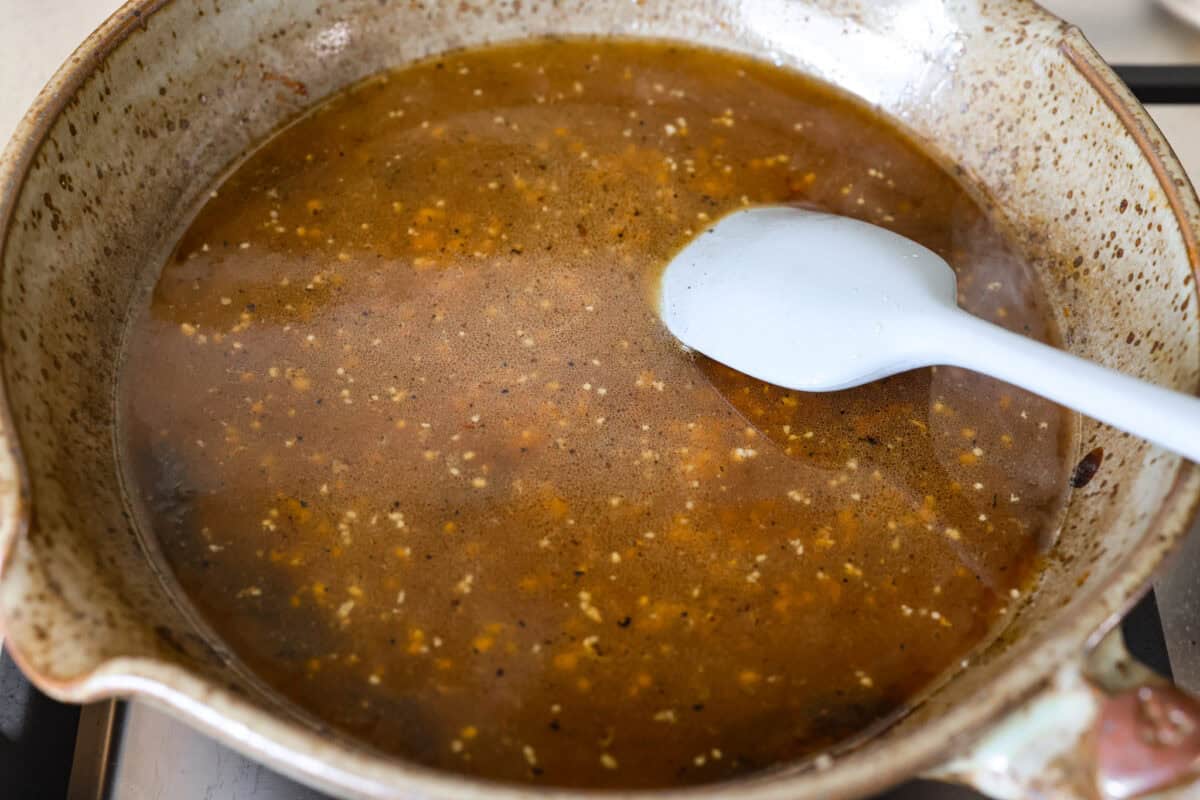 I'm excited for you guys to try this cream cheese chicken. It's an easy one-pan dinner with a rich, creamy sauce that delivers pure comfort food vibes. Itโs quick to make, easy to clean up, and perfect for cozying up on a busy night. Melted butter, minced garlic, and chicken broth added to the skillet.