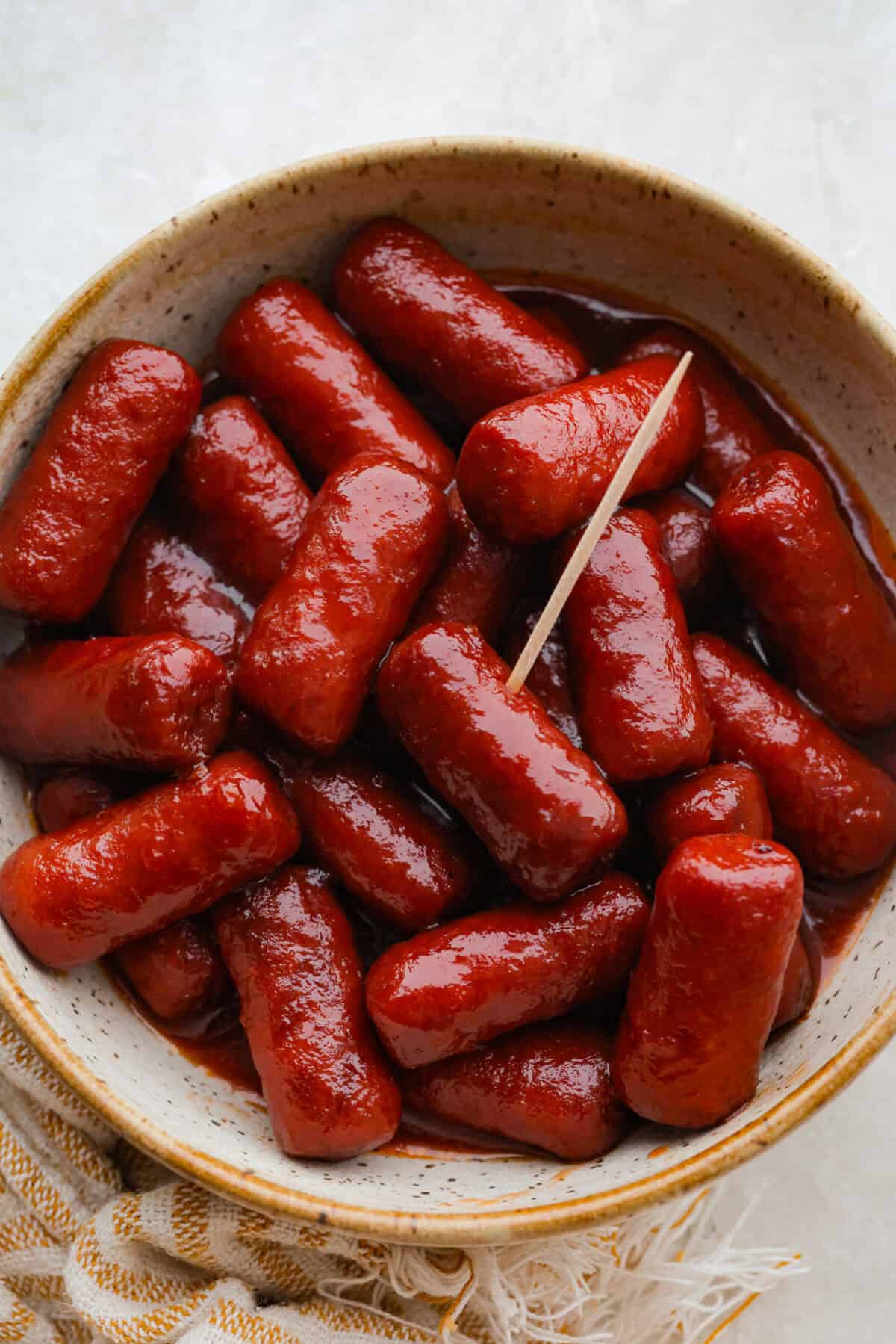 If youโre hosting anything and need a quick appetizer, these crockpot grape jelly little smokies are it. Dump everything in the slow cooker, walk away, and come back to glossy, flavorful sausages that people hover around all night. Cowl of crockpot grape jelly little smokies with a toothpick, ready to serve.