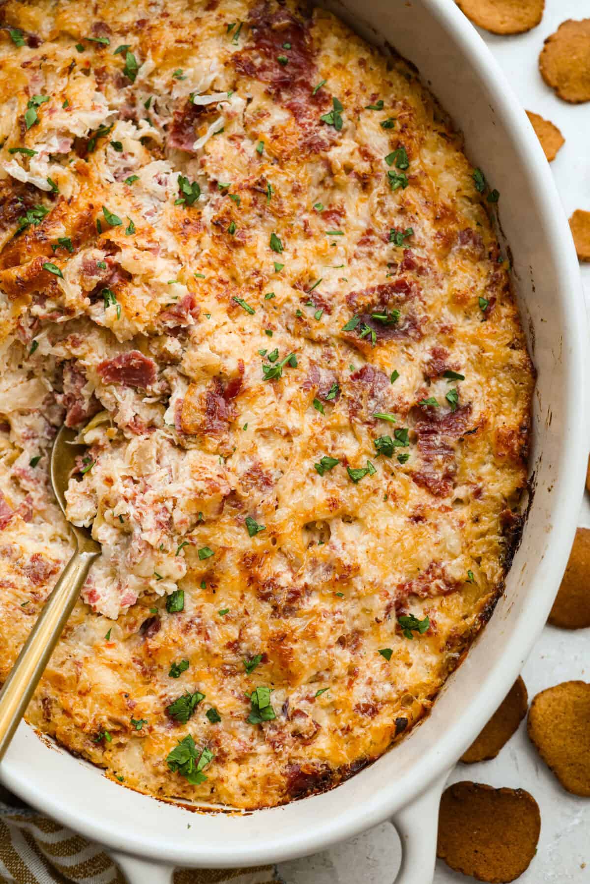 Think of this hot Reuben dip as a love letter to the classic Reuben sandwich. Itโs rich, tangy, loaded with corned beef and sauerkraut, and the perfect way to turn St. Patrickโs Day leftovers into something everyone fights over. Overhead shot of hot reuben dip baked up to perfection!