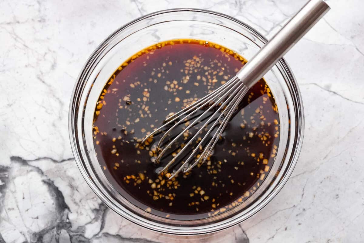 Slow cooker bourbon meatballs are an easy, set-it-and-forget-it favorite. Frozen meatballs simmer in a sweet, sticky bourbon sauce, making them perfect for an appetizer or a simple dinner with just 10 minutes of prep. All of the sauce ingredients all whisked together in a bowl.