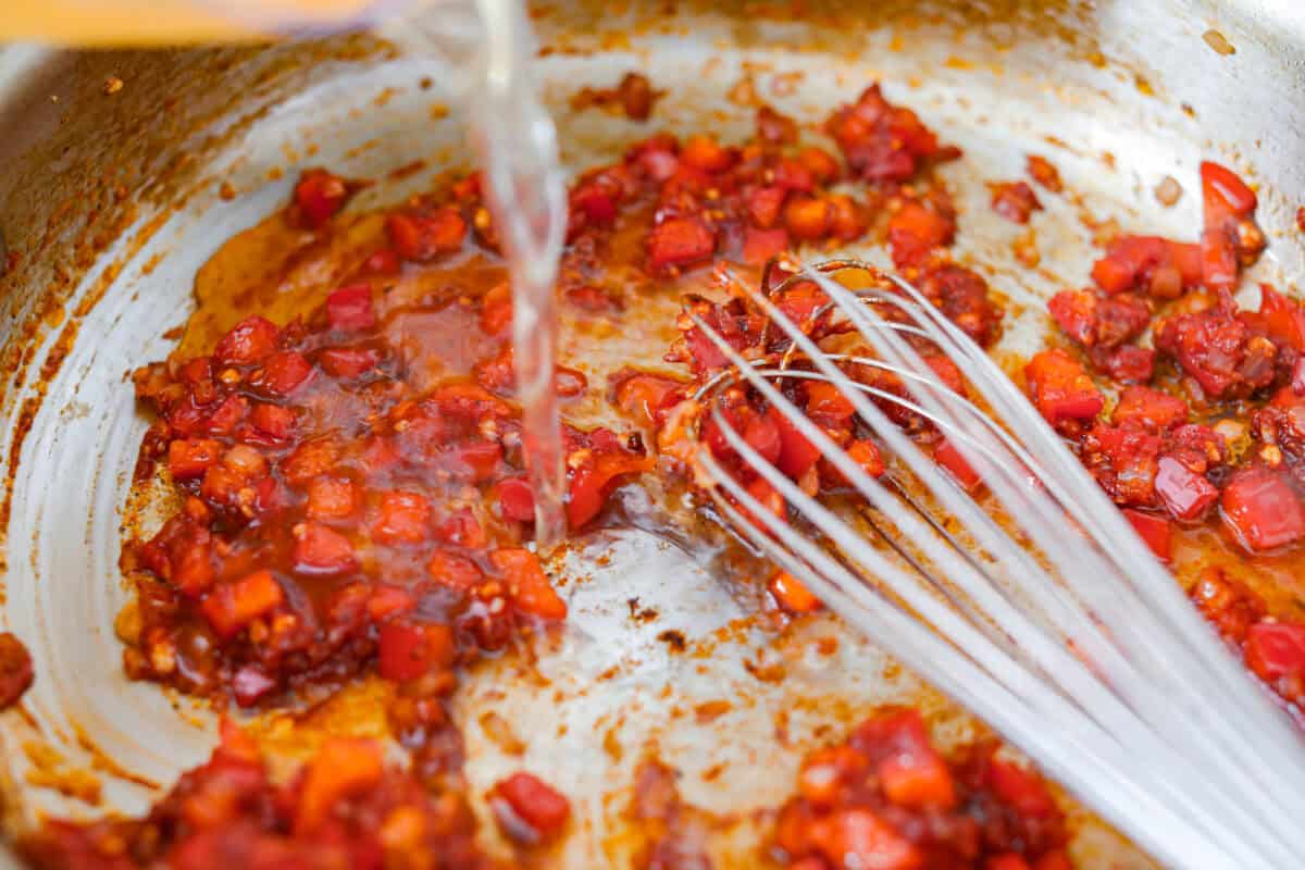 This Cajun spaghetti is comforting like classic spaghetti but delivers a bold Cajun kick with sausage and a creamy sauce. You'll have a super flavorful dinner your whole family will love in no time! Seasoning and chicken broth added to the veggies.