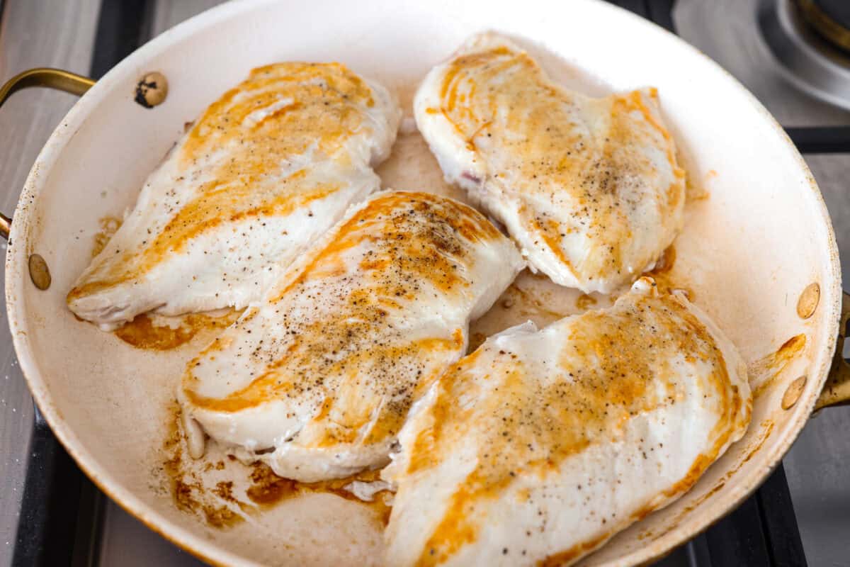 This crockpot chicken marsala brings restaurant-style flavor straight to your slow cooker. Tender chicken, mushrooms, and a rich marsala sauce come together for an effortless dinner youโll want on repeat. Chicken breasts searing in a pan.
