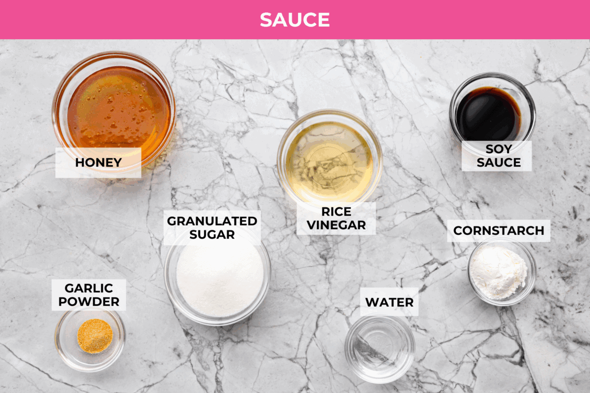 Skip takeout and make this PF Chang’s honey chicken in your own kitchen! Crispy fried chicken gets coated in a glossy honey sauce that’s sweet, savory, and hard to resist Overhead shot of labeled PF Chang's honey chicken sauce ingredients.