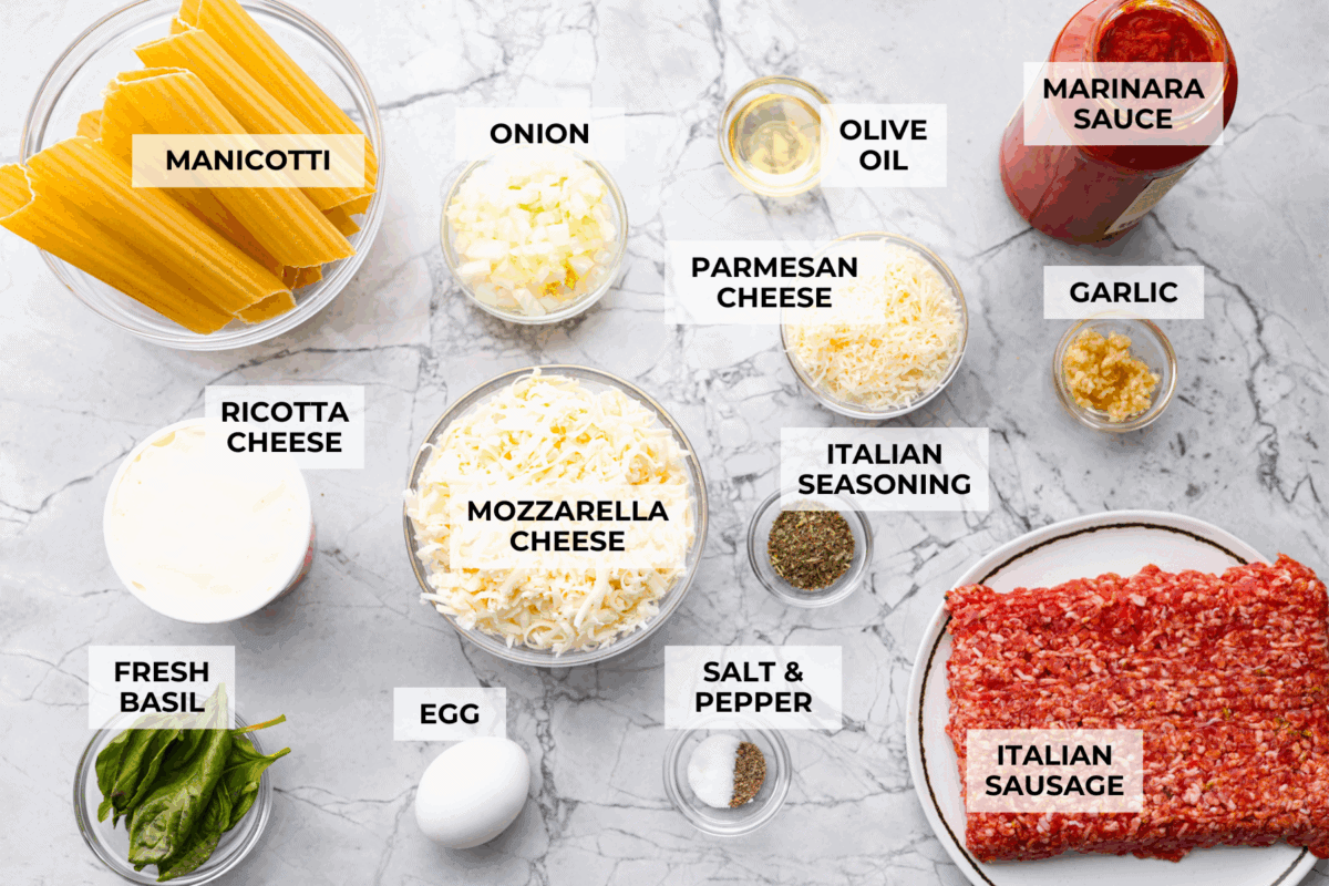 My classic manicotti is a reader favorite, so I wanted to make a version with a little more protein. Sausage is one of my favorite pasta add-ins, and it keeps this new Sausage Manicotti budget-friendly, hearty, cheesy, and so satisfying. Overhead shot of labeled sausage manicotti ingredients.