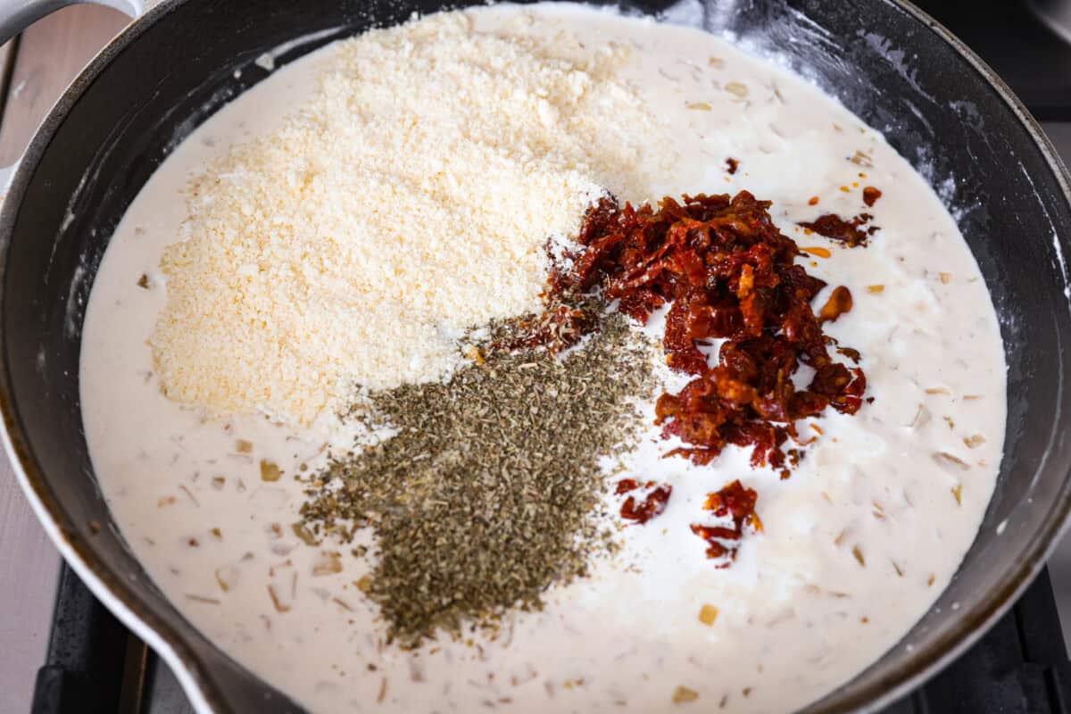 Groceries are expensive right now, so Iโve been leaning hard on the cheap staples. This melting cabbage with a garlicky cream sauce, sun-dried tomatoes, and Parmesan is easy, budget friendly, and tastes amazing. Parmesan, sun dried tomatoes, and seasonings added to the skillet.