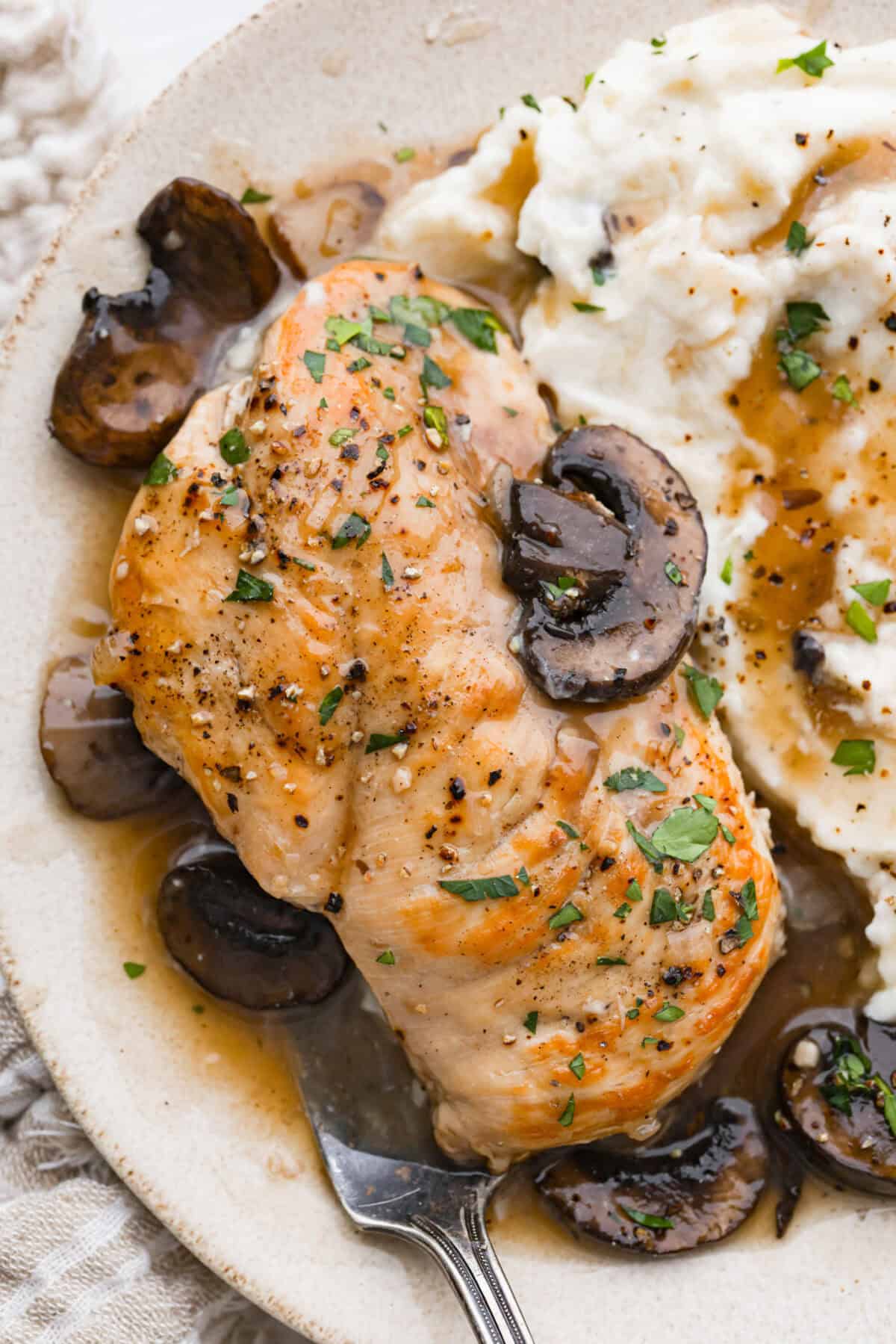 This crockpot chicken marsala brings restaurant-style flavor straight to your slow cooker. Tender chicken, mushrooms, and a rich marsala sauce come together for an effortless dinner youโll want on repeat. Plated crockpot chicken marsala next to mashed potatoes.