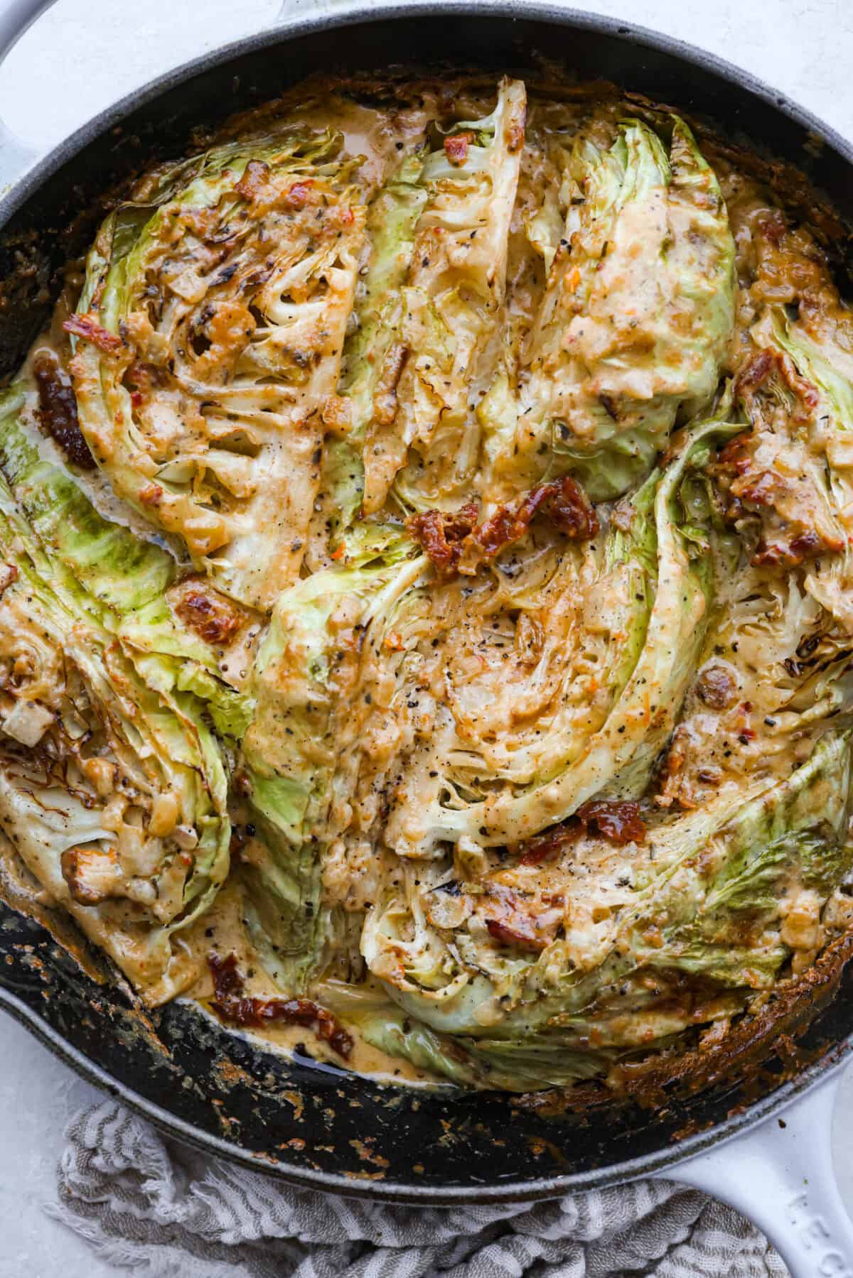 Groceries are expensive right now, so Iโve been leaning hard on the cheap staples. This melting cabbage with a garlicky cream sauce, sun-dried tomatoes, and Parmesan is easy, budget friendly, and tastes amazing. Skillet with creamy tuscan melting cabbage all cooked and ready to eat.