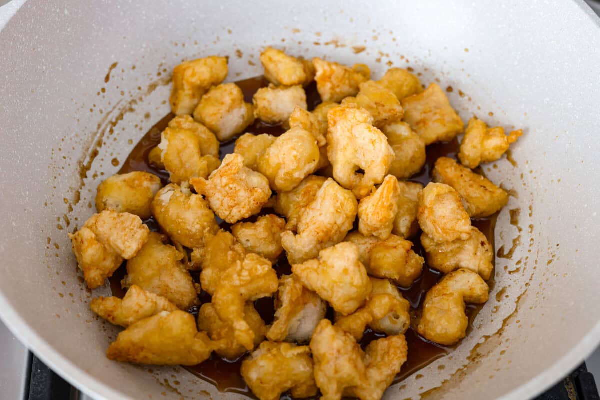 Skip takeout and make this PF Chang’s honey chicken in your own kitchen! Crispy fried chicken gets coated in a glossy honey sauce that’s sweet, savory, and hard to resist Fried chicken pieces added to the sauce in the wok.