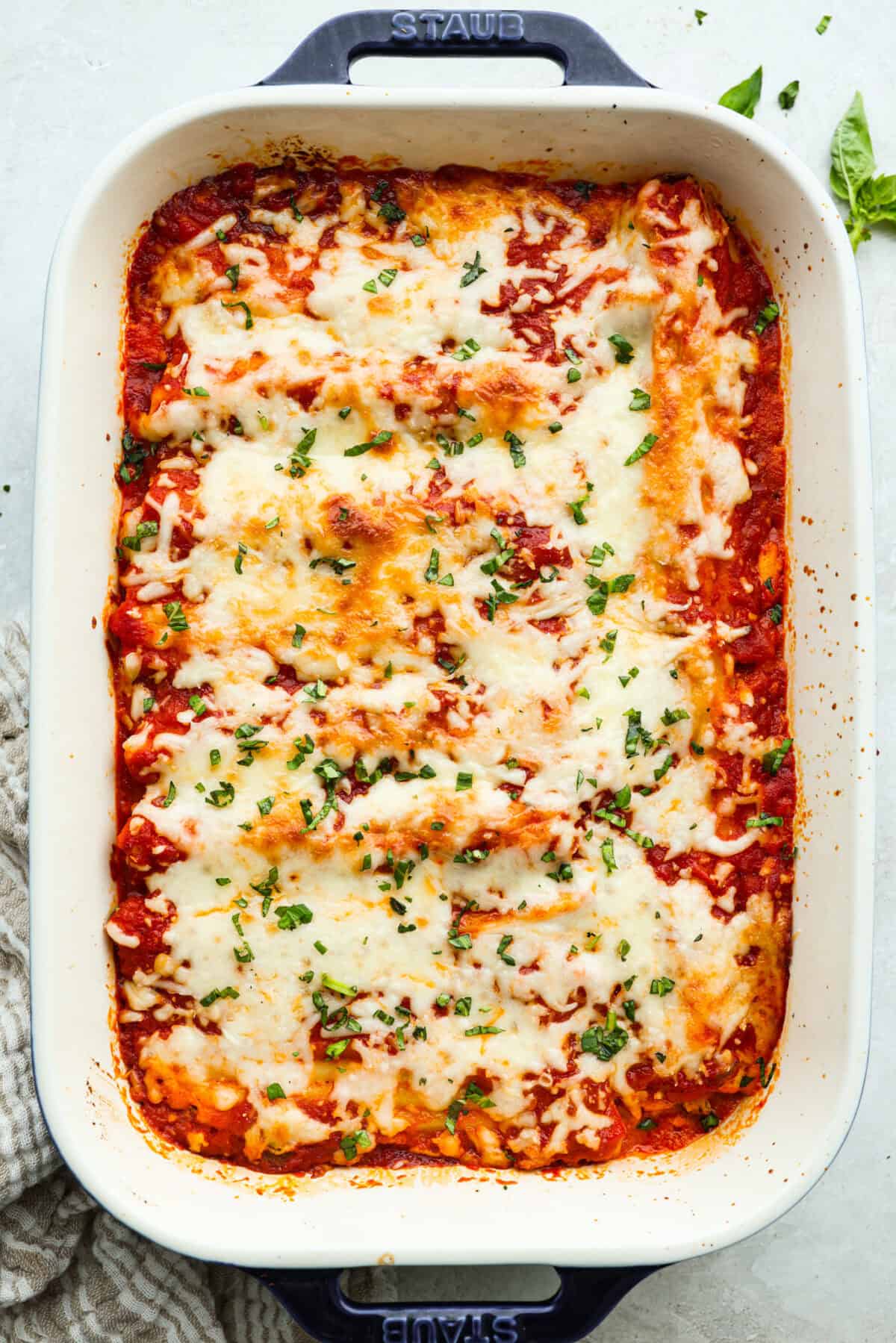 My classic manicotti is a reader favorite, so I wanted to make a version with a little more protein. Sausage is one of my favorite pasta add-ins, and it keeps this new Sausage Manicotti budget-friendly, hearty, cheesy, and so satisfying. Overhead shot of the baked sausage manicotti.