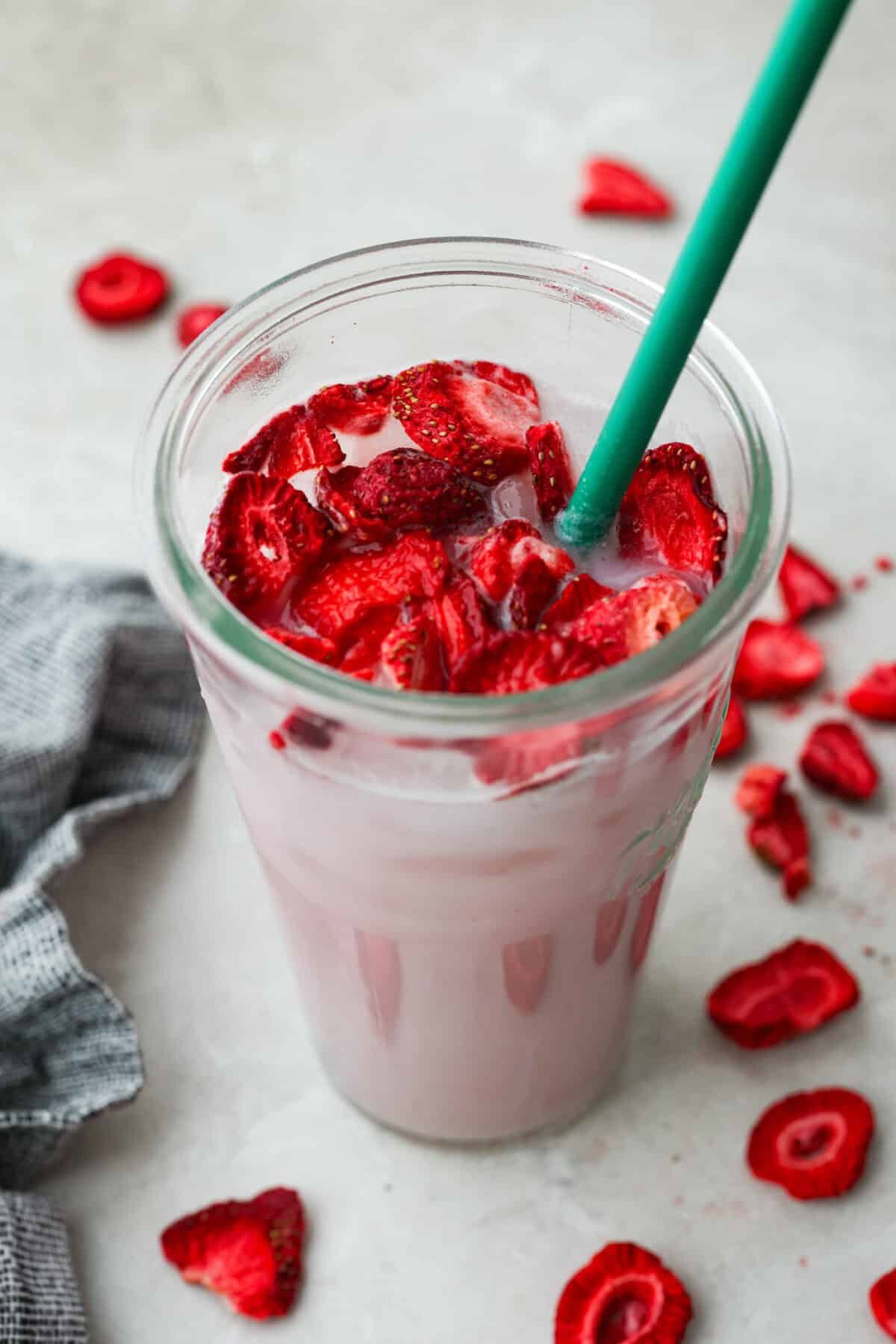 You guys, Starbucks sells the Strawberry Aรงaรญ concentrate in stores! Which means we can make the famous Starbuck's Pink Drink at home! And let me tell you, it's spot on! With just three ingredients, it's ridiculously easy to make year-round, and so good! Top angle shot of the Starbucks copycat pink drink.