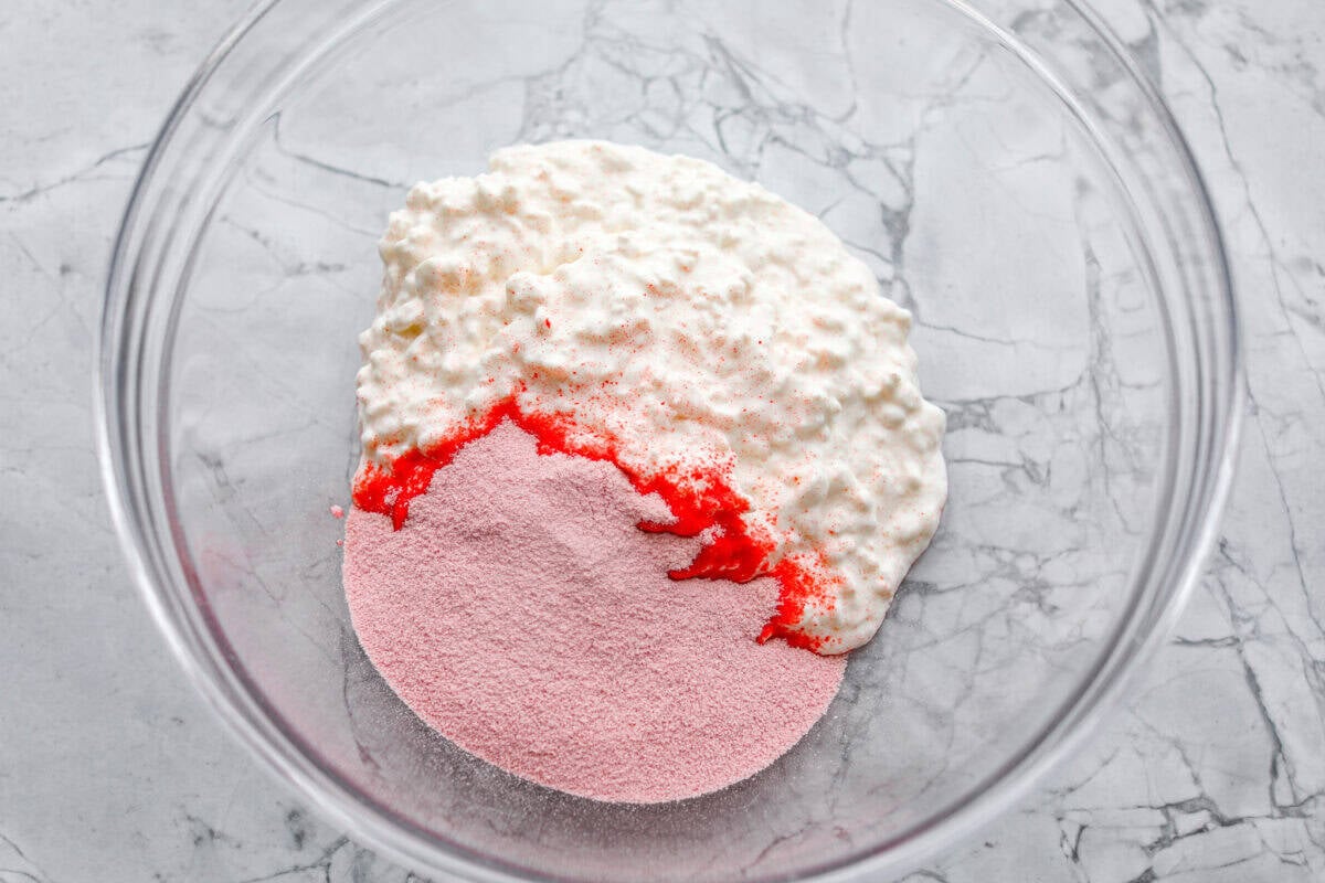 This cottage cheese jello salad is one of those old-school recipes that never really goes out of style. My dad absolutely loves it and requests it all the time, especially for family get-togethers. Itโs creamy, fruity, and ridiculously easy to make. Cottage cheese and Jello packet dumped in a large bowl.