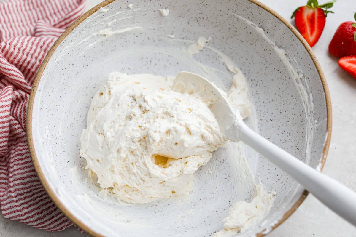 Crack pretzel salad is the shortcut version of my popular strawberry pretzel salad! It has all the sweet, salty, creamy goodness you love, but this version comes together in less than 15 minutes for an easy dessert everyone goes crazy for. Cream cheese mixture with whipped topping folded in.