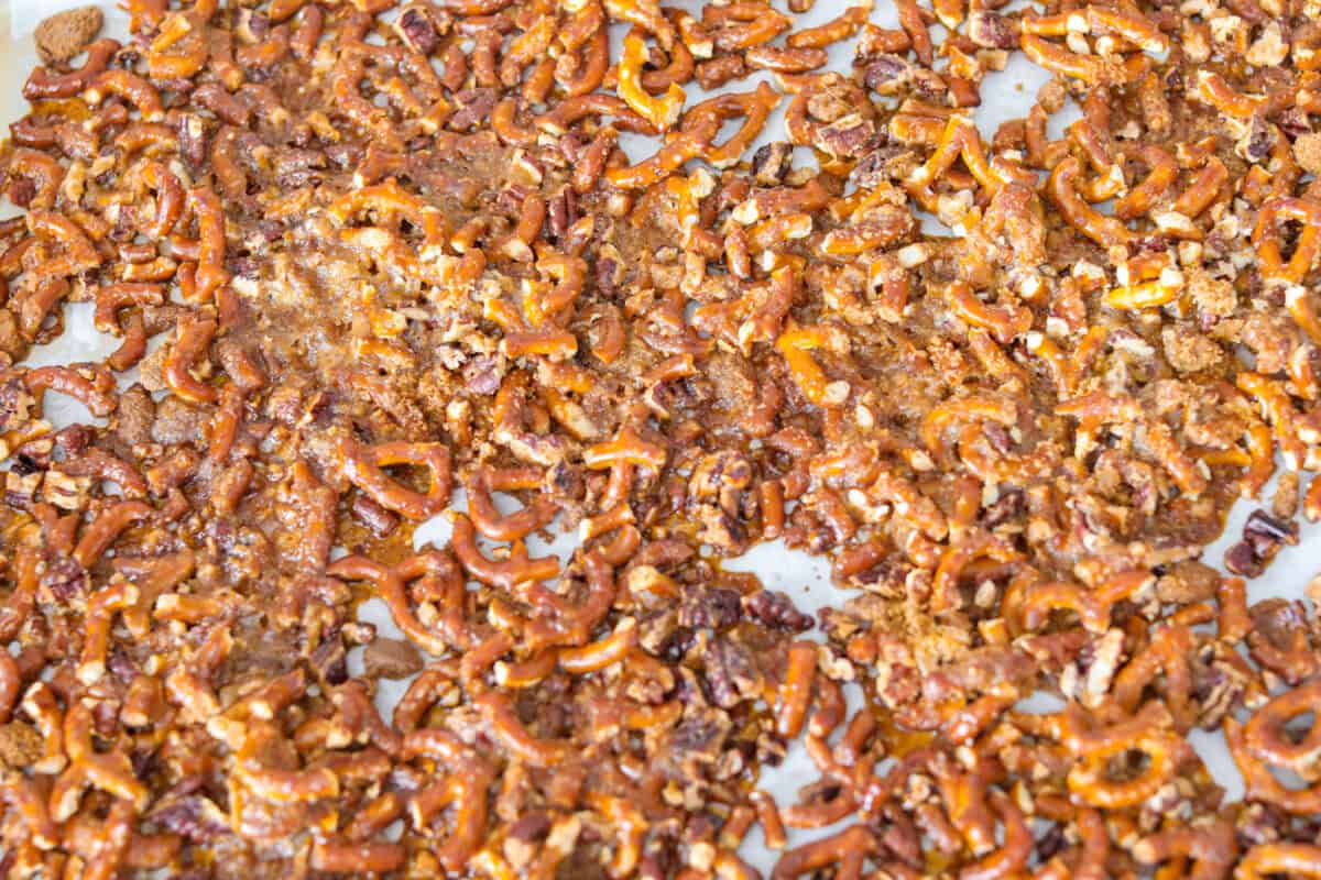Crack pretzel salad is the shortcut version of my popular strawberry pretzel salad! It has all the sweet, salty, creamy goodness you love, but this version comes together in less than 15 minutes for an easy dessert everyone goes crazy for. Crack pretzel mixture cooked and hardened on a cookie sheet.