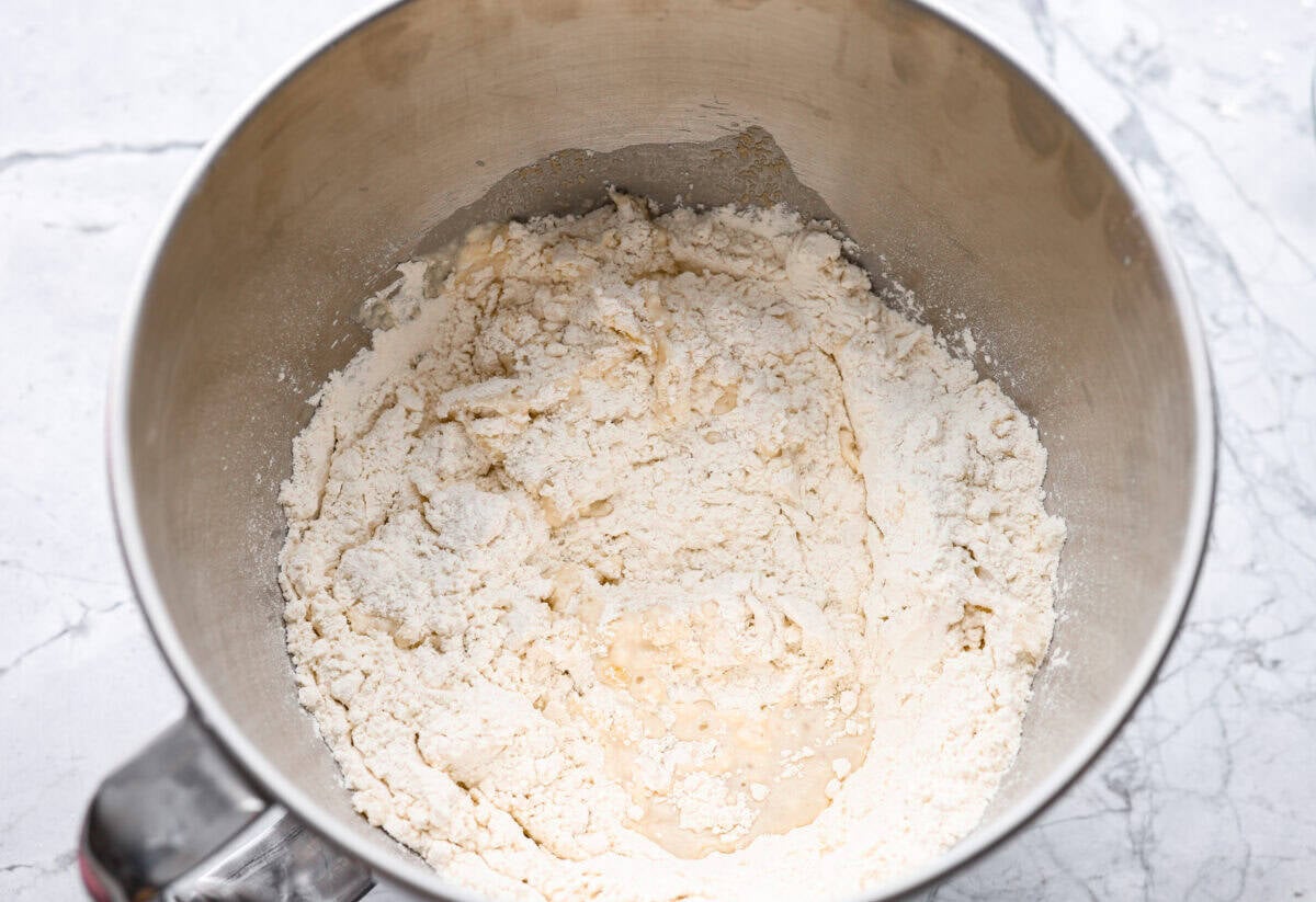 If warm, homemade bread is your weakness, youโre going to love these French bread rolls. Theyโre soft, chewy, and perfect for everything from weeknight dinners to holiday meals. Warm water, yeast, sugar oil, salt, and flour all added to the bowl of a stand mixer.