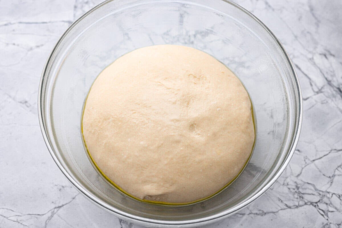 If warm, homemade bread is your weakness, youโre going to love these French bread rolls. Theyโre soft, chewy, and perfect for everything from weeknight dinners to holiday meals. Dough ball in the bottom of a bowl rising.