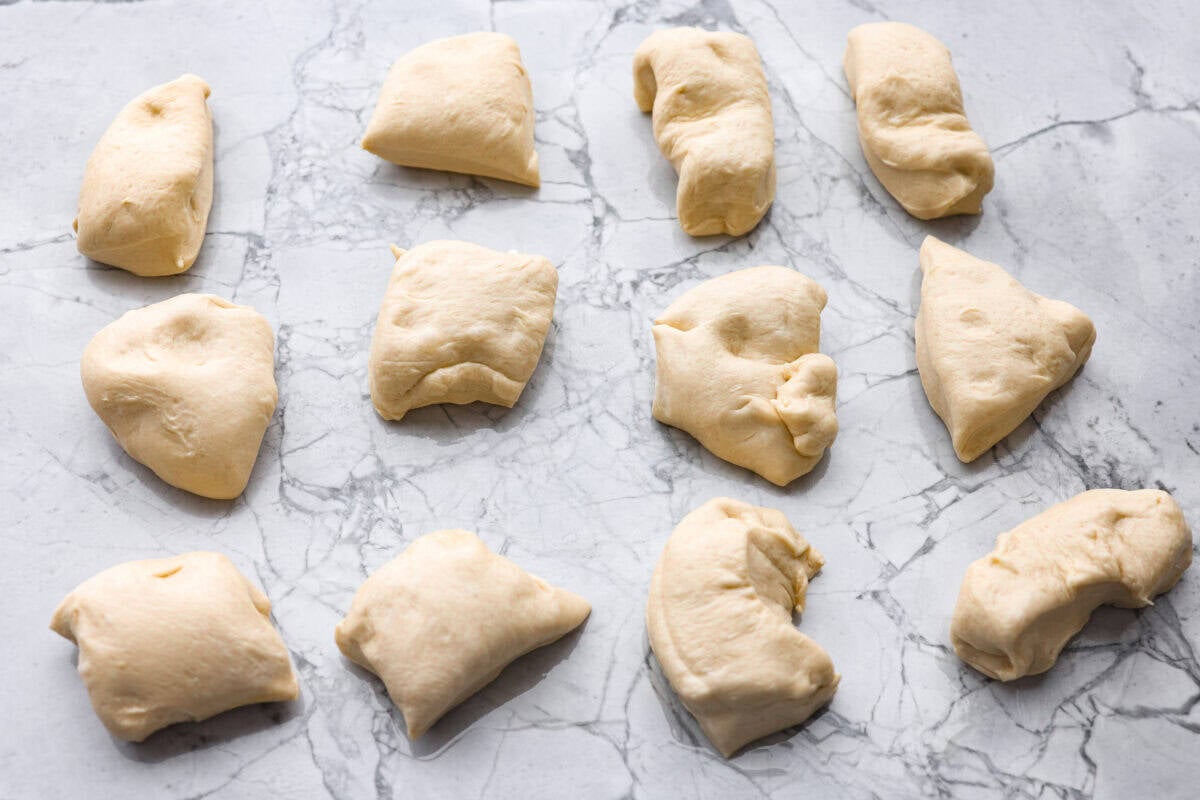 If warm, homemade bread is your weakness, youโre going to love these French bread rolls. Theyโre soft, chewy, and perfect for everything from weeknight dinners to holiday meals. Pieces of dough cut into sections.