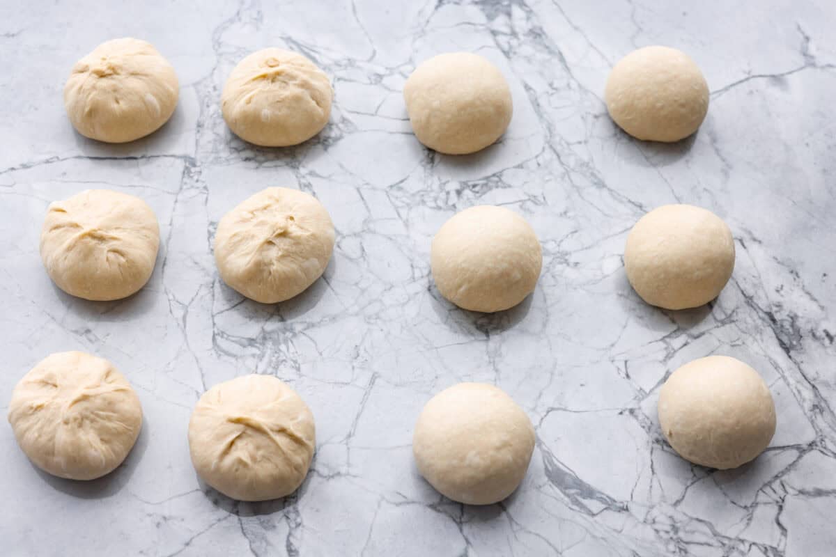 If warm, homemade bread is your weakness, youโre going to love these French bread rolls. Theyโre soft, chewy, and perfect for everything from weeknight dinners to holiday meals. Dough sections rolled into balls.