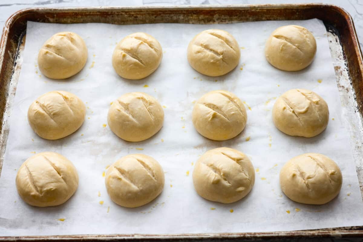 If warm, homemade bread is your weakness, youโre going to love these French bread rolls. Theyโre soft, chewy, and perfect for everything from weeknight dinners to holiday meals. French bread dough balls scoured and covered in an egg wash, ready to go in the oven.