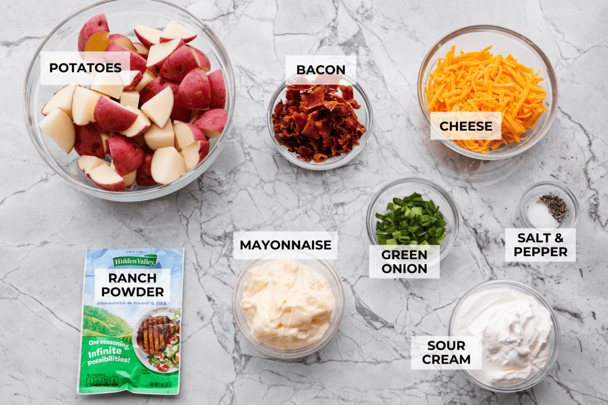 You guys have been asking, so I made the change. This Crack Potato Salad now has mayonnaise in the dressing! It seriously takes the flavors up a notch! I love the combination with the sour cream. I can't wait for you to try this new version! Overhead shot of labeled crack potato salad ingredients.
