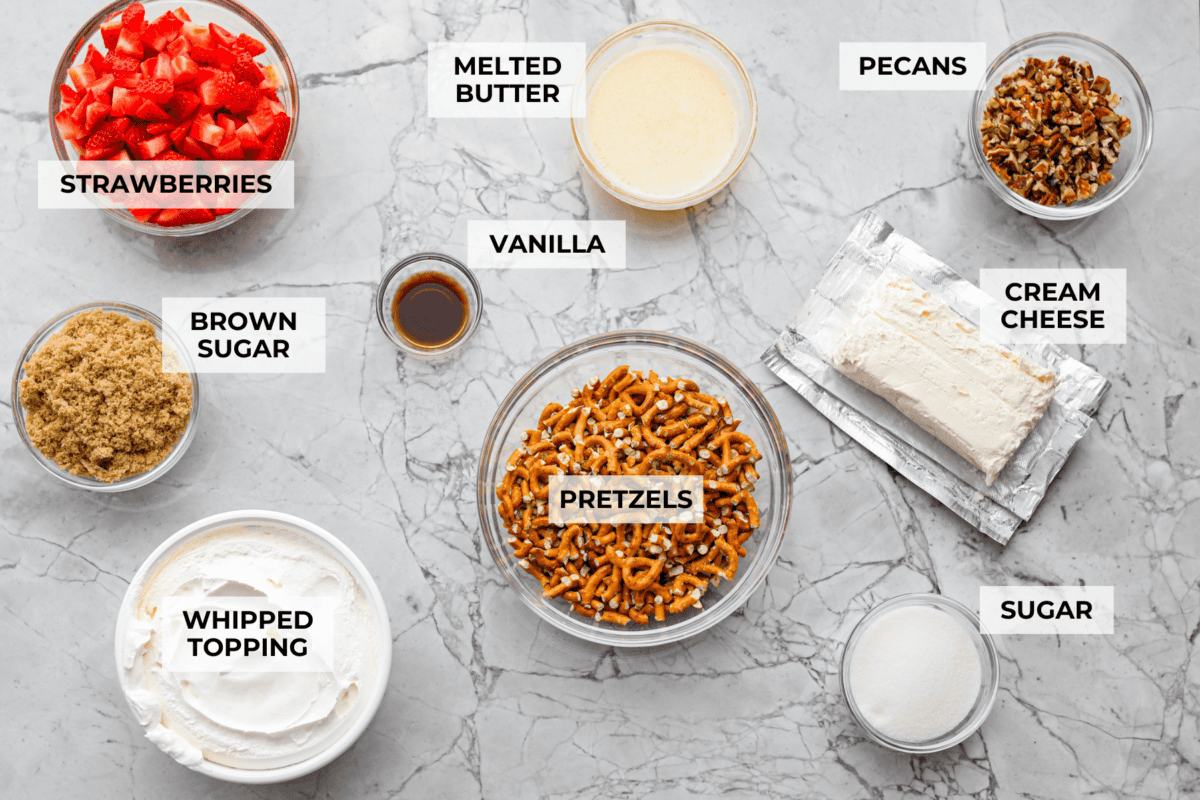 Crack pretzel salad is the shortcut version of my popular strawberry pretzel salad! It has all the sweet, salty, creamy goodness you love, but this version comes together in less than 15 minutes for an easy dessert everyone goes crazy for. Overhead shot of labeled crack pretzel salad ingredients.