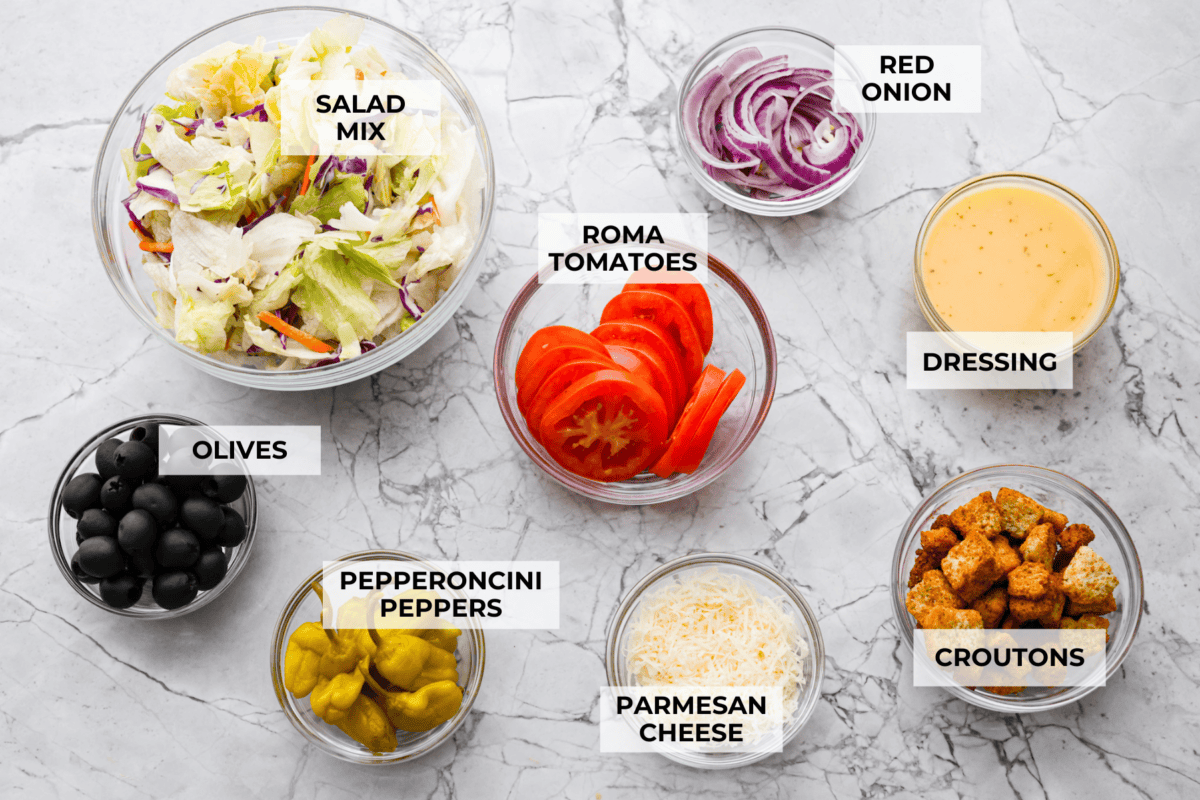 Copycat Olive Garden Salad is one of my all-time favorite restaurant salads, and now you can make it right at home. Itโs bright, zesty, and packed with that fresh, irresistible flavor everyone loves. Overhead shot of labeled ingredients.