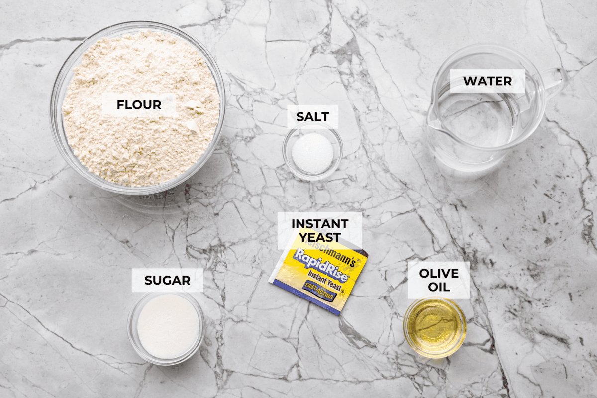 If you’ve ever wanted homemade bread without all the work, this slow cooker bread is my favorite easy trick. As a busy mom, I love that a few simple ingredients and my slow cooker turn into a warm, soft loaf with hardly any effort. Overhead shot of labeled slow cooker bread ingredients.