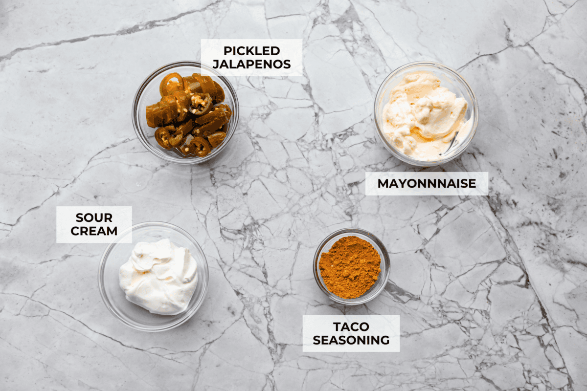 This copycat Taco Bell quesadilla sauce is about to become a staple in your fridge. Made with just four ingredients in five minutes, itโs a breeze to whip up. The taste is so spot-on, youโll be drizzling it on everything! Overhead shot of labeled Taco Bell quesadilla sauce ingredients.