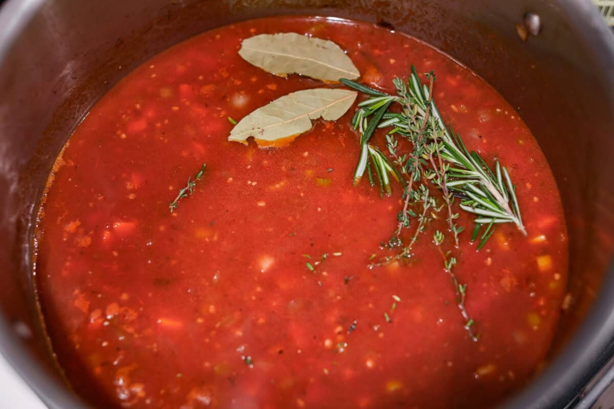 Herbs and tomatoes added to the mixture.