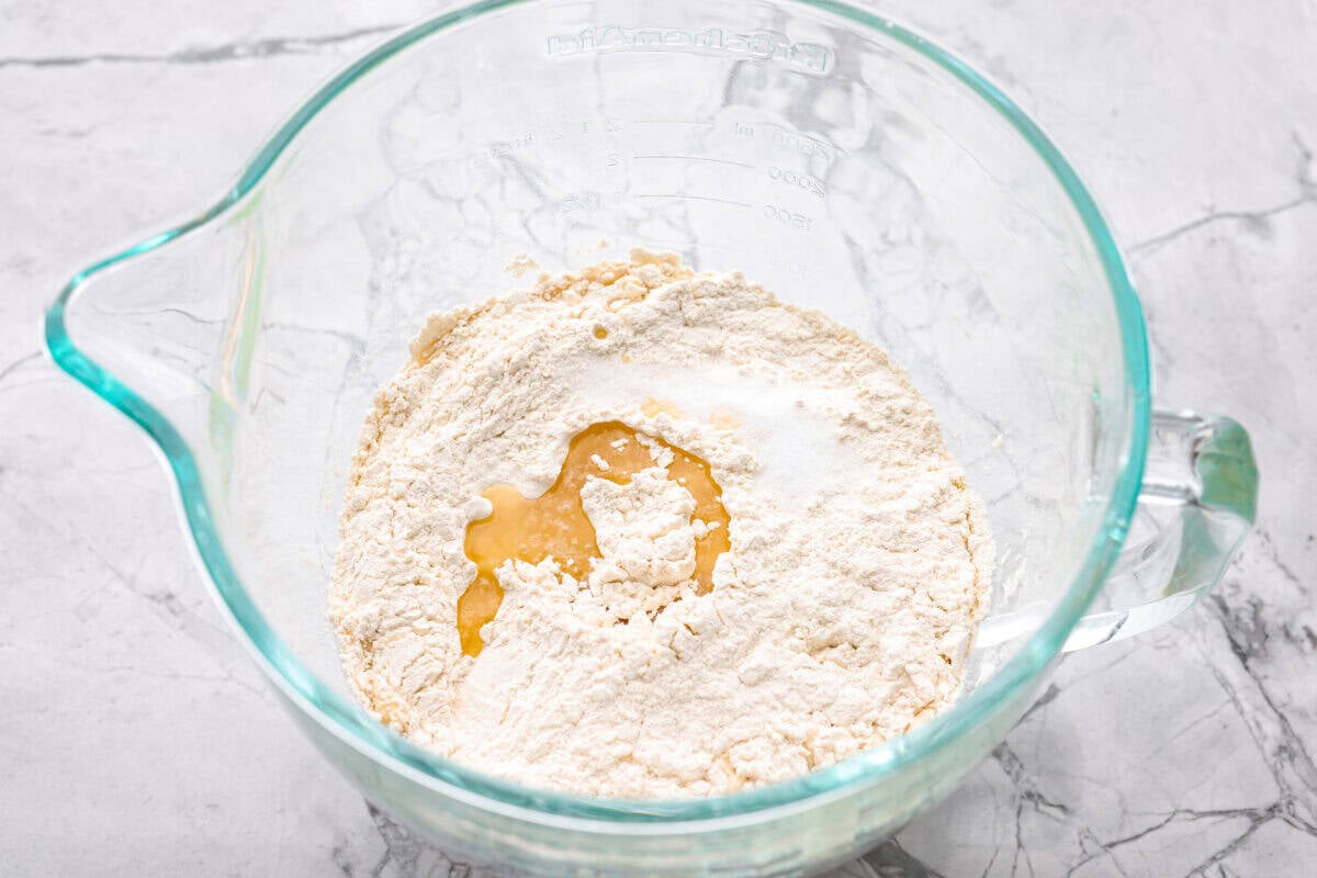 If you’ve ever wanted homemade bread without all the work, this slow cooker bread is my favorite easy trick. As a busy mom, I love that a few simple ingredients and my slow cooker turn into a warm, soft loaf with hardly any effort. Flour, olive oil and salt added to the yeast mixture.