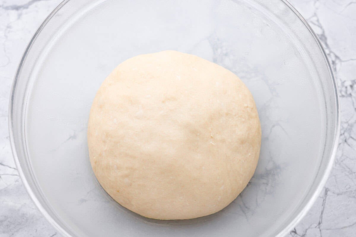 If you’ve ever wanted homemade bread without all the work, this slow cooker bread is my favorite easy trick. As a busy mom, I love that a few simple ingredients and my slow cooker turn into a warm, soft loaf with hardly any effort. Ball of dough that has been left to rise and doubled in size.