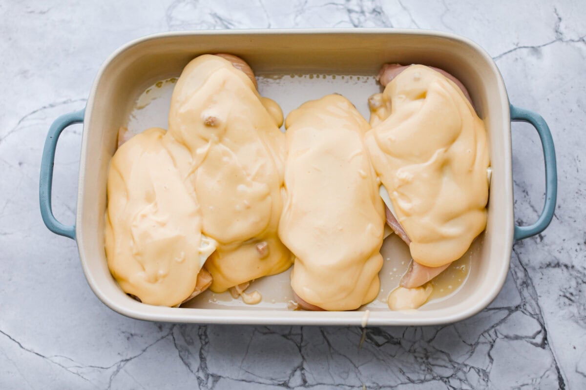 Okay, this Swiss Chicken Casserole is my go-to when I donโt feel like cooking. You basically throw it together, pop it in the oven, and somehow end up with super tender chicken, melty Swiss cheese, and the creamiest sauce. Soup mixture spread over the cheese on top of the chicken breasts.