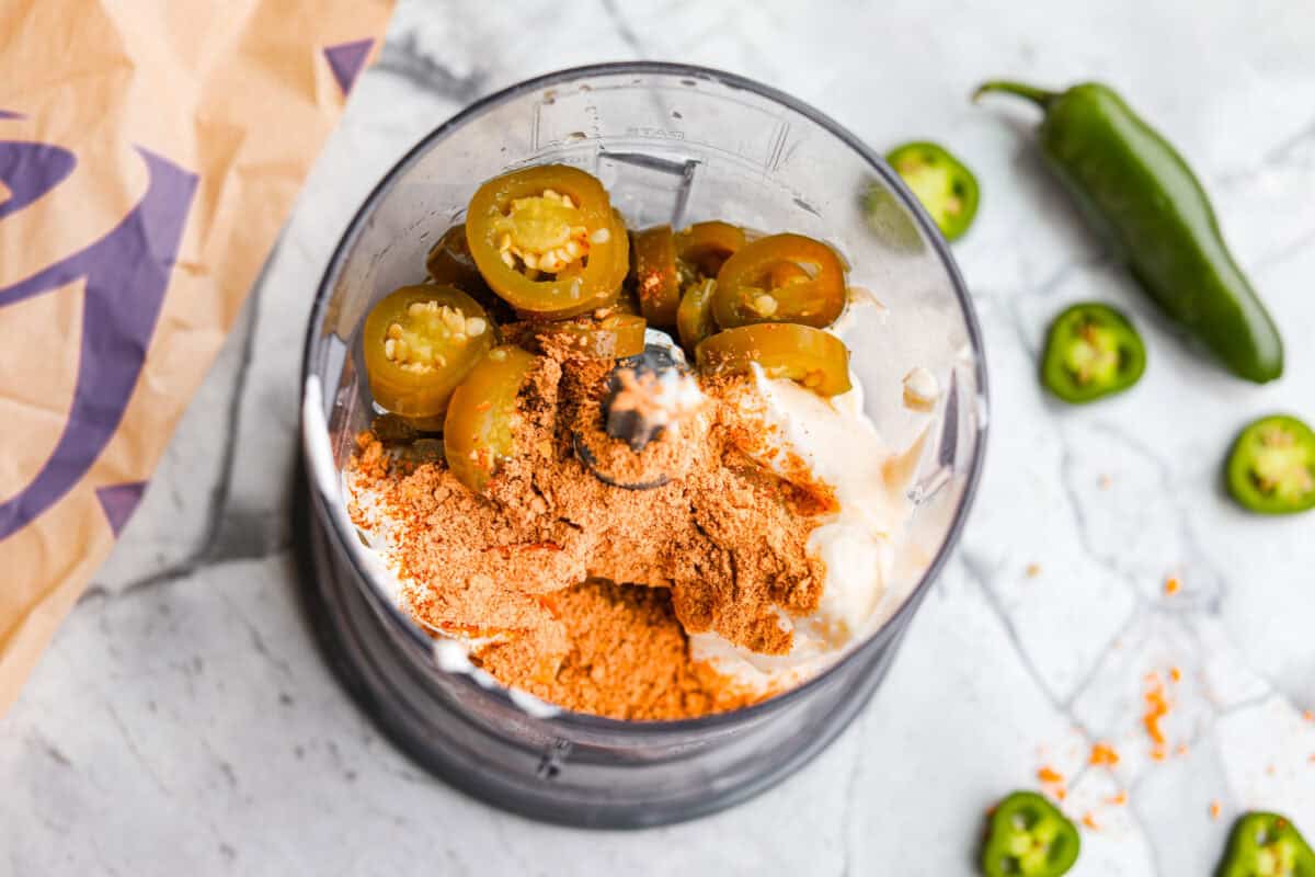 Serve: Enjoy with fresh quesadillas or use as a dipping sauce for your favorite Tex-Mex meals.ย I love this sauce drizzled over chicken burrito bowls! Food processor filled with all of the ingredients ready to be blended together.