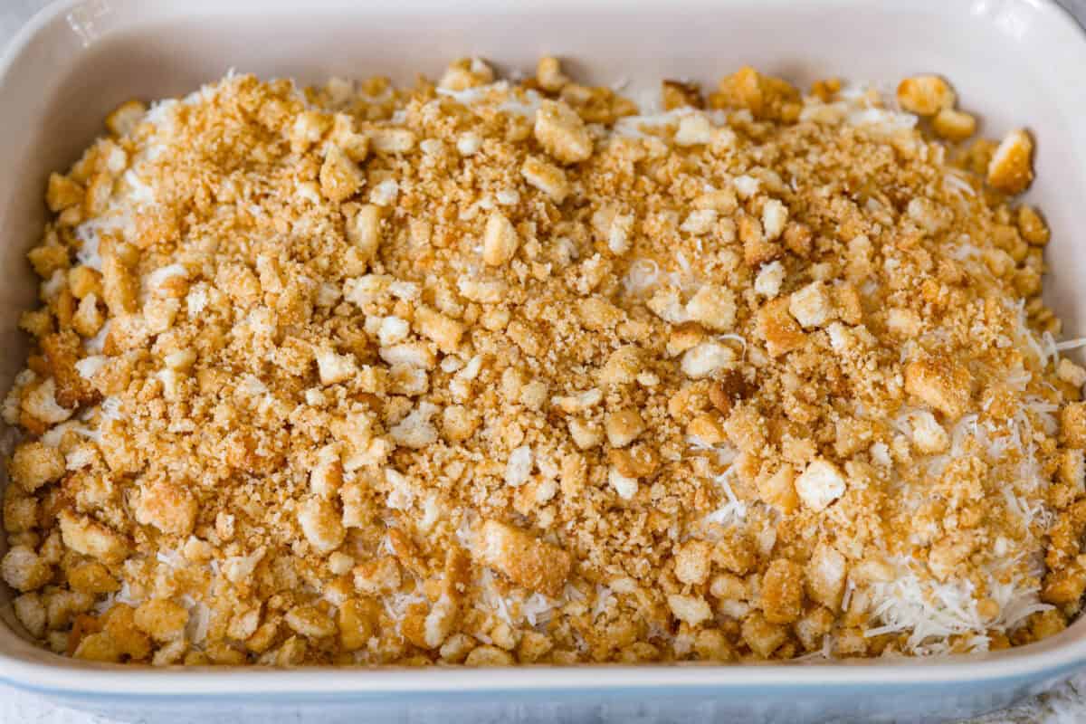 My Caesar chicken bakeย turns classic Caesar salad flavors into an easy one-pan dinner! Juicy chicken is smothered in creamy dressing, topped with parmesan and buttery crushed croutons, and baked to golden, cheesy perfection. Crushed croutons on top of the parmesan cheese.