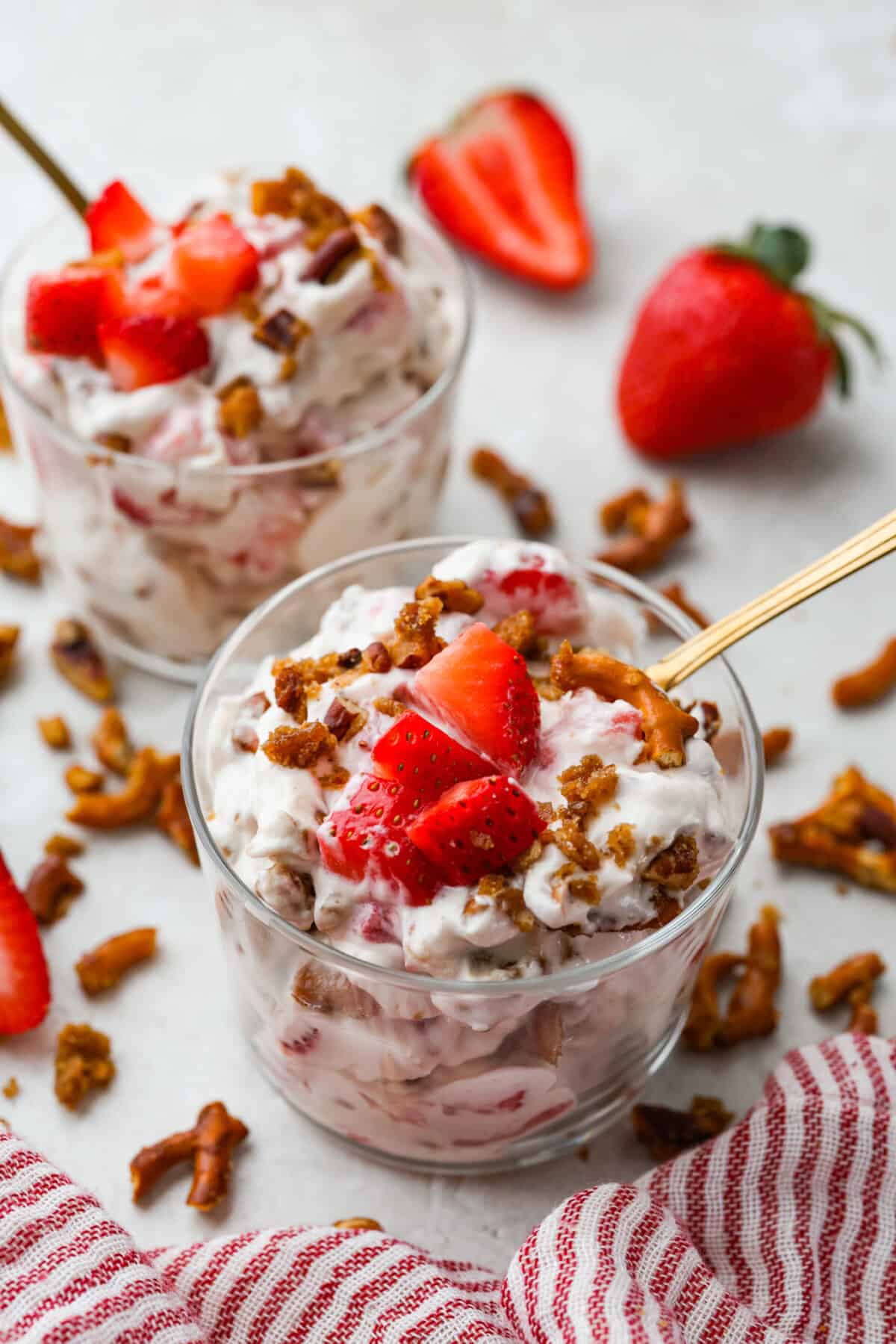 Crack pretzel salad is the shortcut version of my popular strawberry pretzel salad! It has all the sweet, salty, creamy goodness you love, but this version comes together in less than 15 minutes for an easy dessert everyone goes crazy for. Serving bowls of crack pretzel salad.