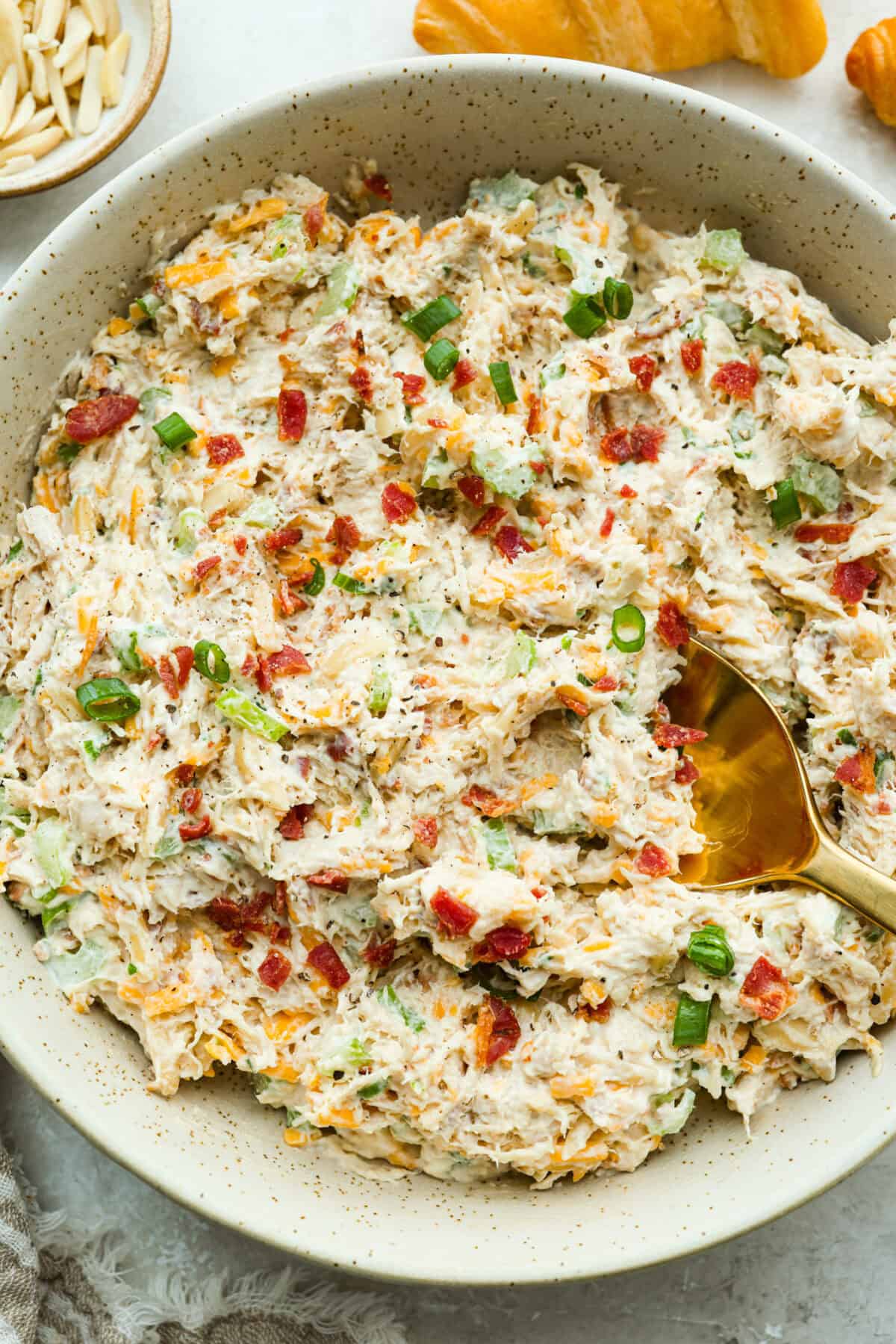 Million dollar chicken salad totally lives up to the name. Itโs creamy, cheesy, crunchy, and packed with bacon, so every bite is full of flavor. Serve it on croissants, with crackers, or straight from the bowl! It's that good. Large bowl of million dollar chicken salad ready to be eaten.