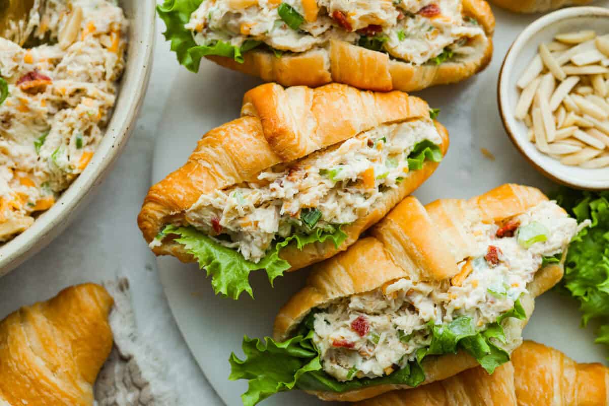 Million dollar chicken salad totally lives up to the name. Itโs creamy, cheesy, crunchy, and packed with bacon, so every bite is full of flavor. Serve it on croissants, with crackers, or straight from the bowl! It's that good. Million dollar chicken salad in croissants with lettuce.