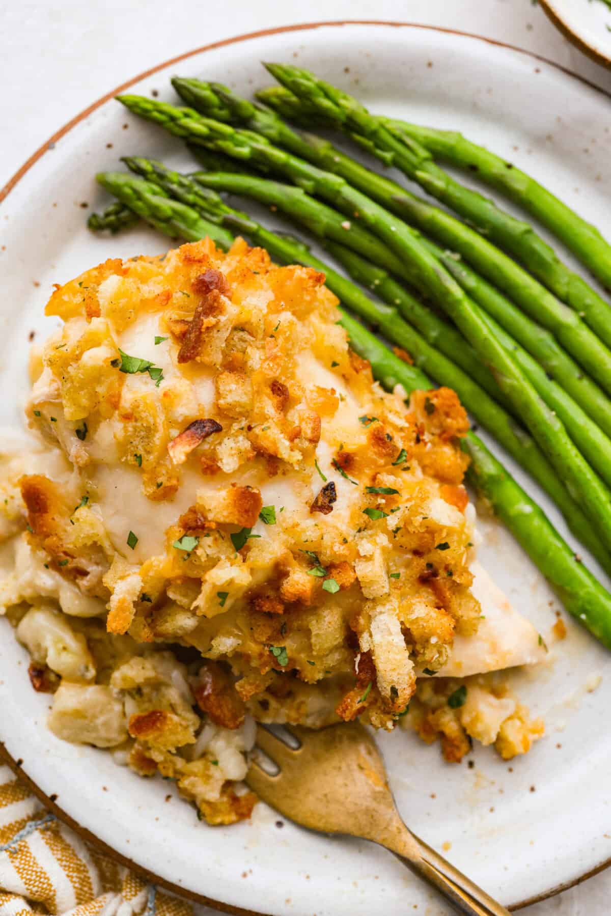 Okay, this Swiss Chicken Casserole is my go-to when I donโt feel like cooking. You basically throw it together, pop it in the oven, and somehow end up with super tender chicken, melty Swiss cheese, and the creamiest sauce. Swiss chicken plated next to some green beans!