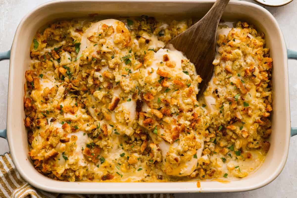 Okay, this Swiss Chicken Casserole is my go-to when I donโt feel like cooking. You basically throw it together, pop it in the oven, and somehow end up with super tender chicken, melty Swiss cheese, and the creamiest sauce. Swiss chicken in a baking dish all ready to be served.